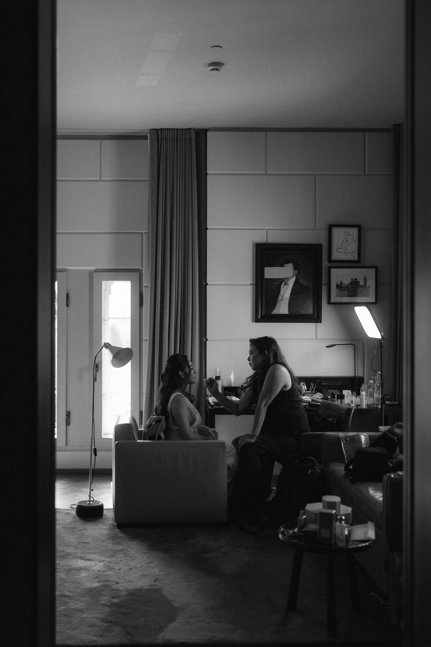 A series of four moody black and white interior room photographs showing silhouettes and furniture in low light.