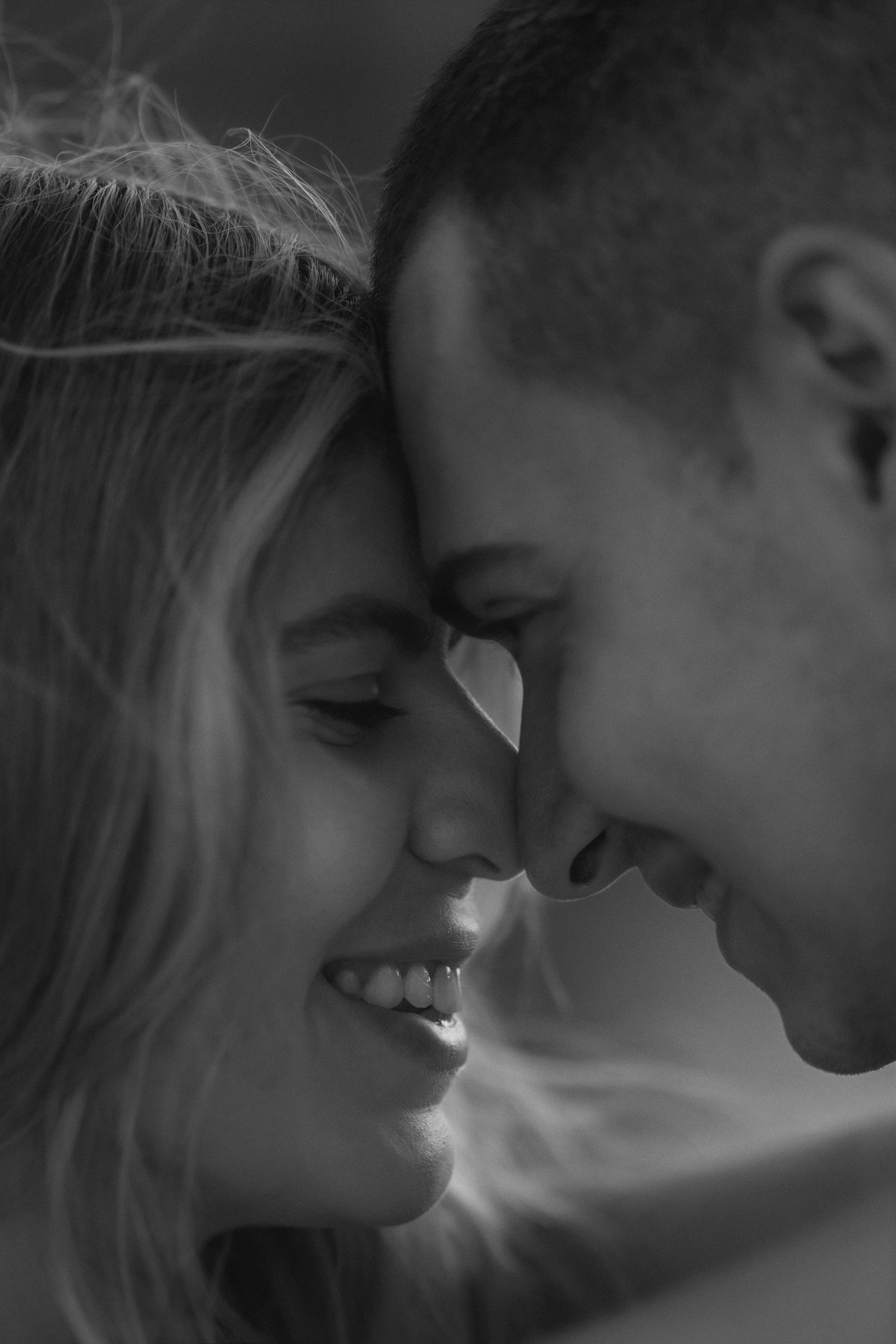 A romantic black and white photo series showing close-up intimate moments between a couple about to kiss.
