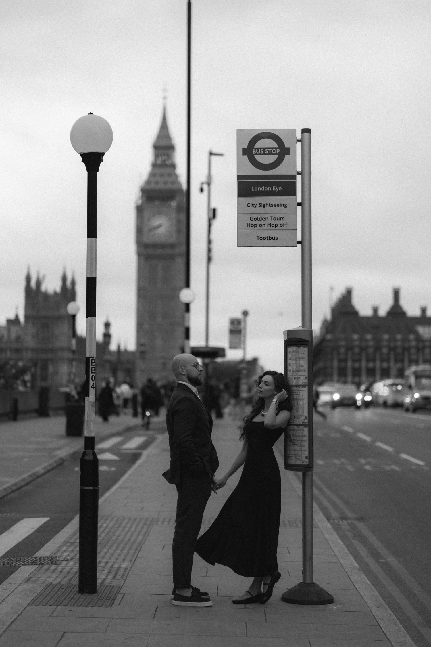 Black and white sequence of people waiting at a London bus stop with Big Ben and Parliament buildings in background.