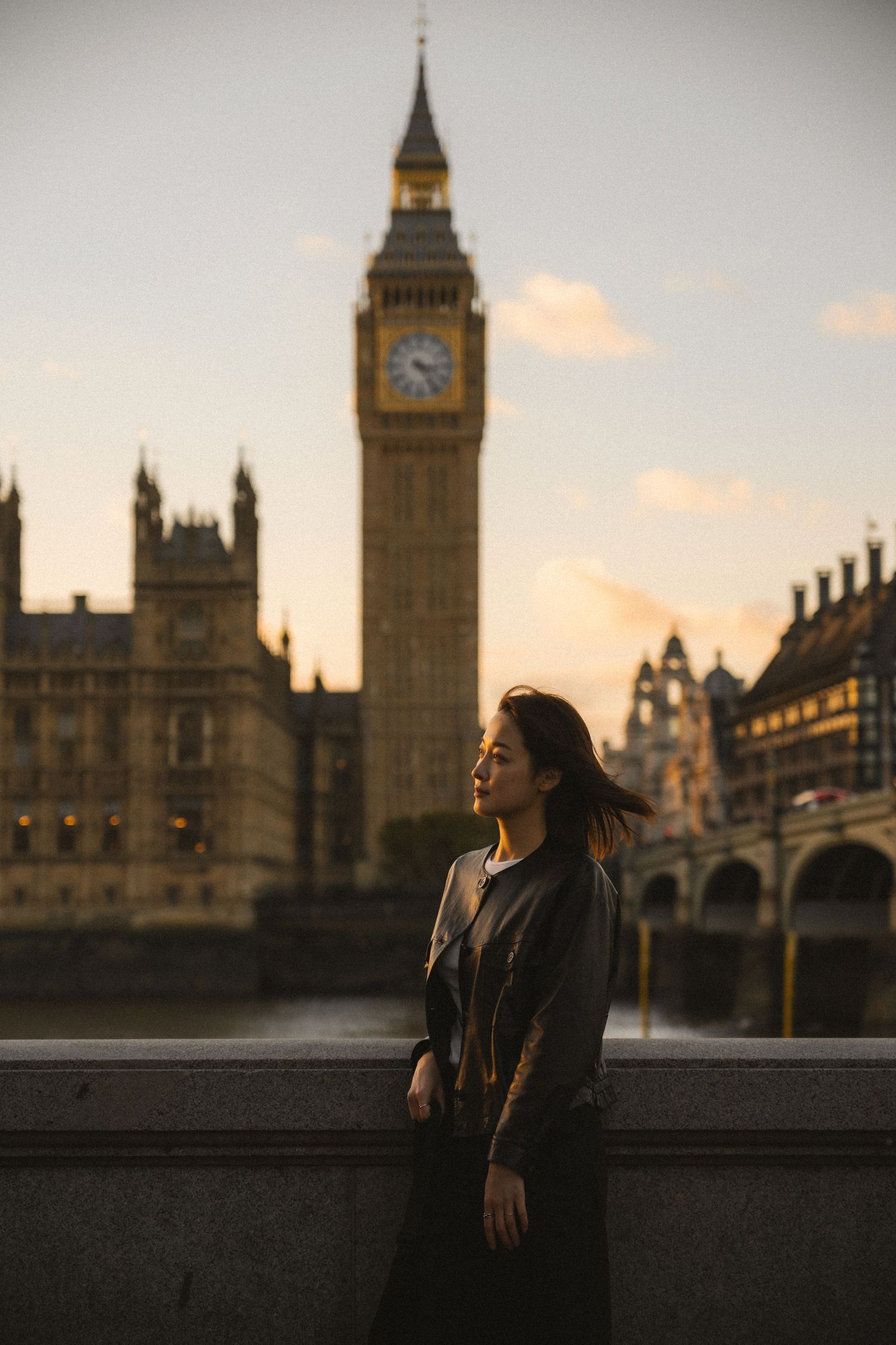 Silhouette against sunset sky with Big Ben and Houses of Parliament in London creating dramatic evening ambiance.
