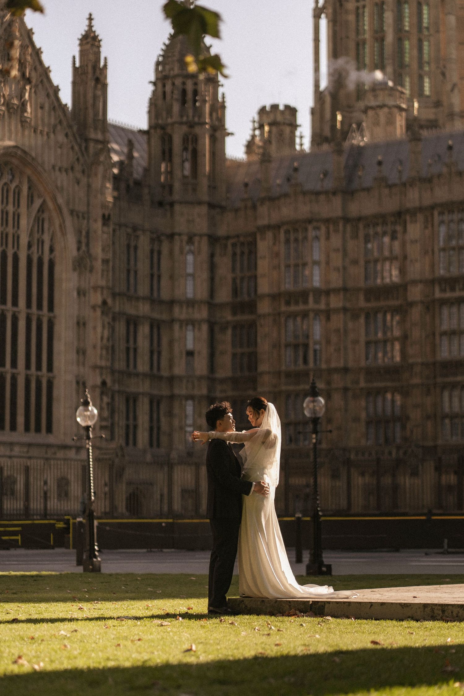 Bride and groom share a romantic dance outside the Houses of Parliament in London on their wedding day.