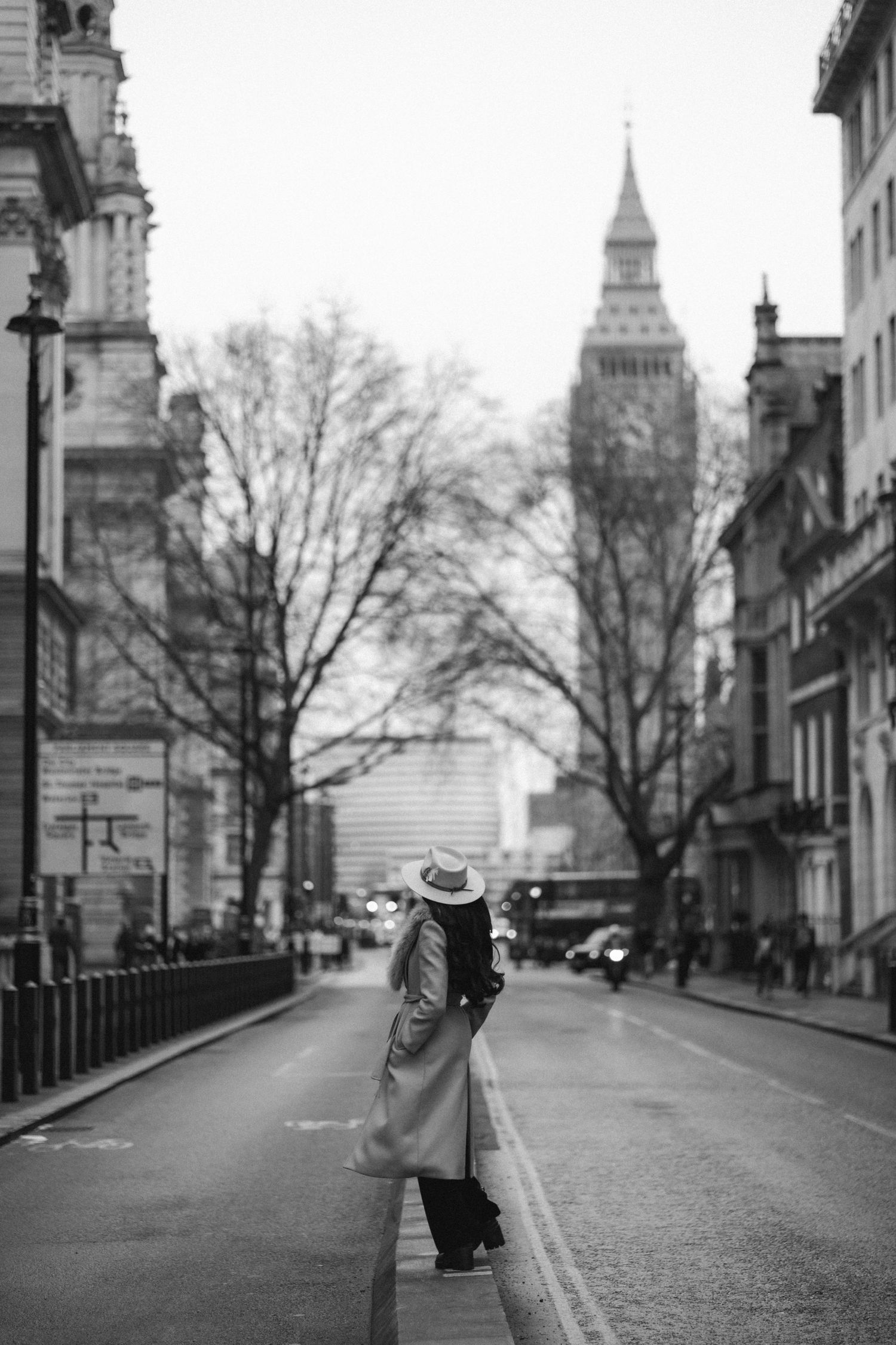 Black and white street scene in Paris showing the Sacre-Coeur Basilica from multiple angles on a quiet day.