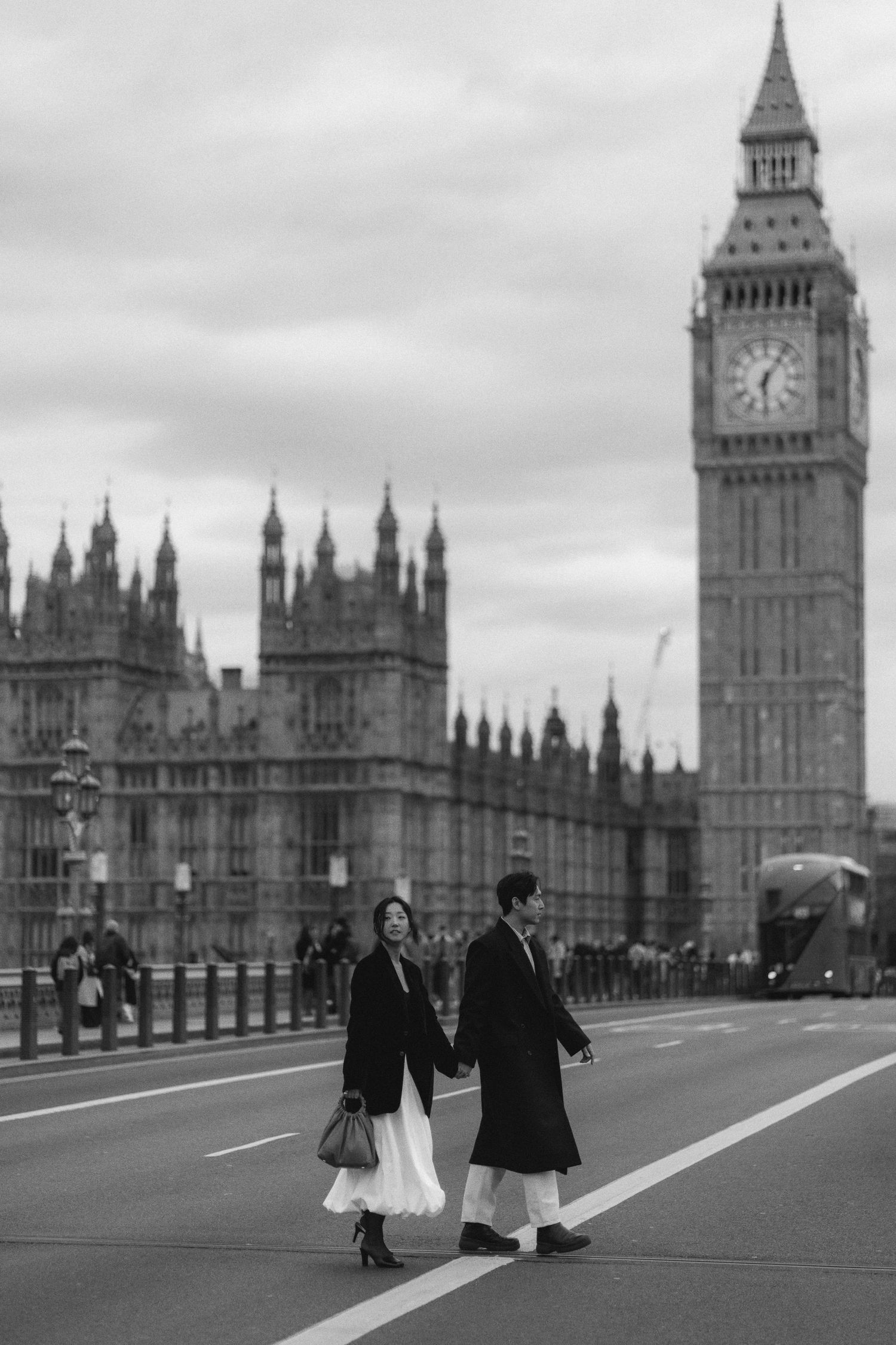 A sequence of black and white photos showing people walking across Westminster Bridge with Big Ben in the background.