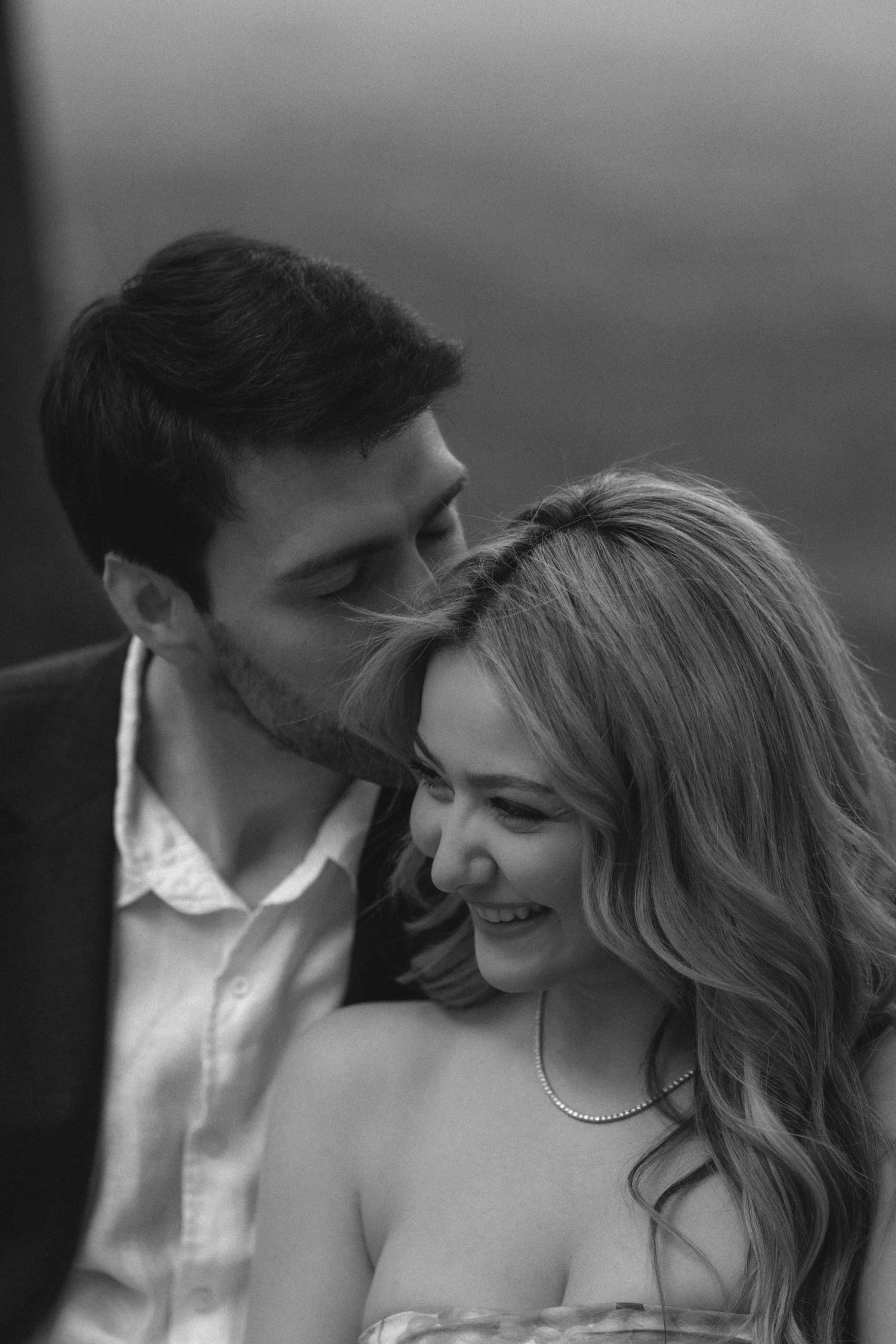 A romantic black and white photo series showing tender moments between a couple in intimate poses.