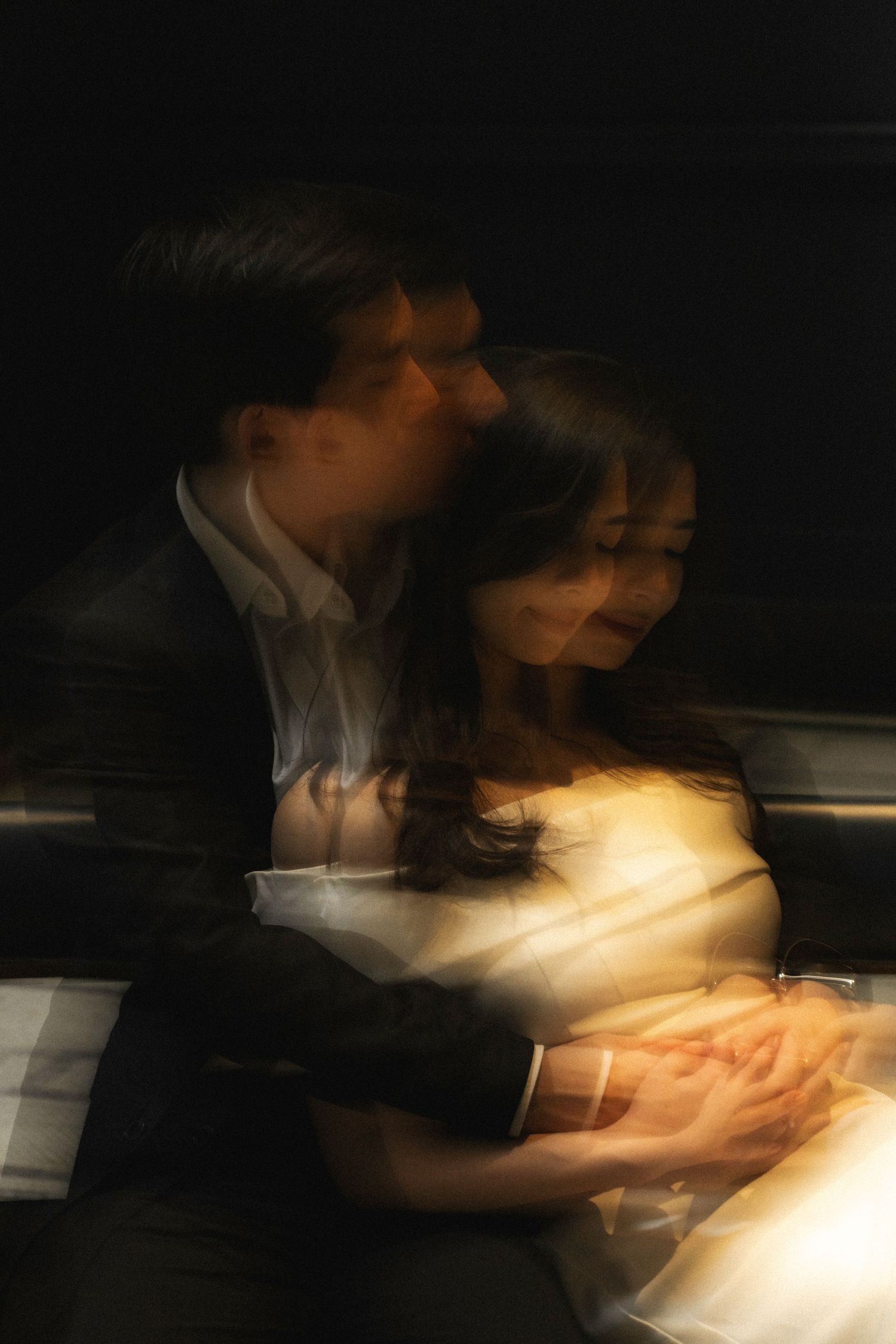 A series of blurred motion photographs showing movement in low light with glowing warm highlights.