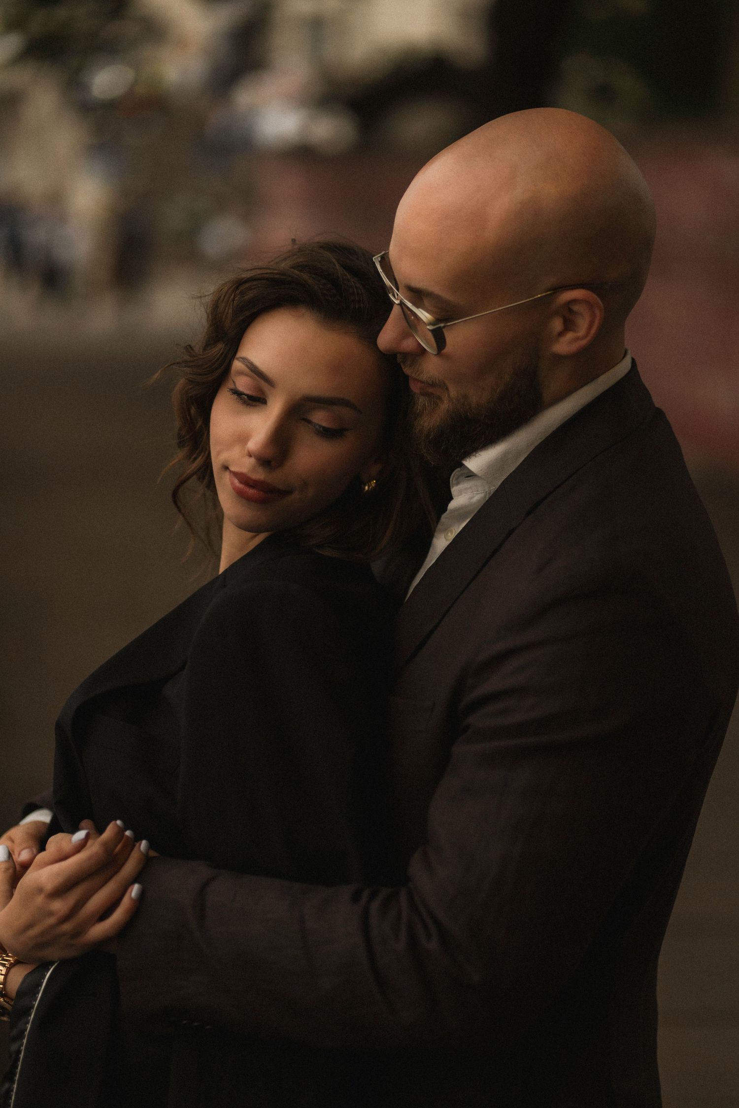 A romantic couple embraces intimately in a dimly lit setting, sharing a tender moment together.