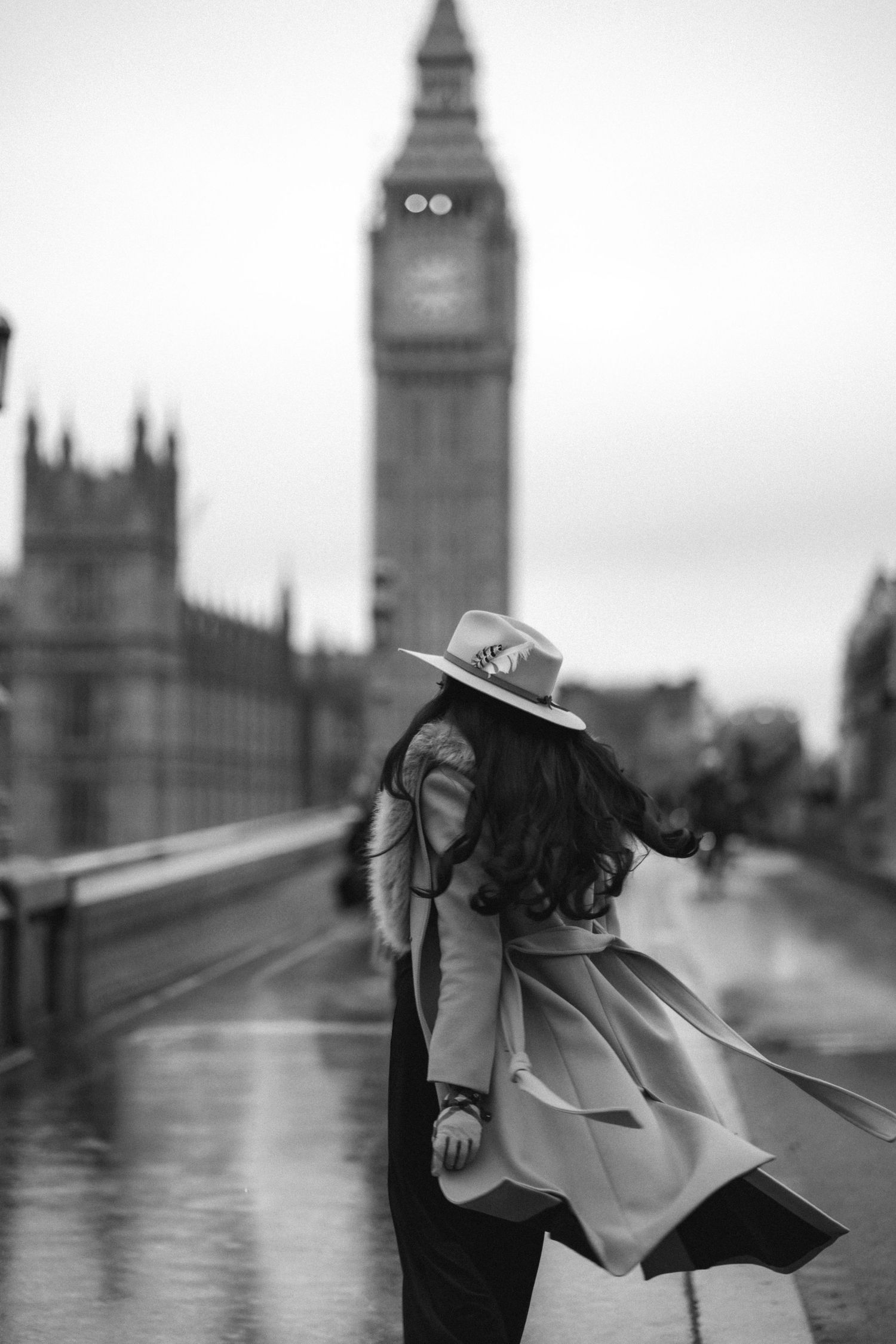 A black and white photo series of a person with an umbrella on Westminster Bridge with Big Ben in the background.