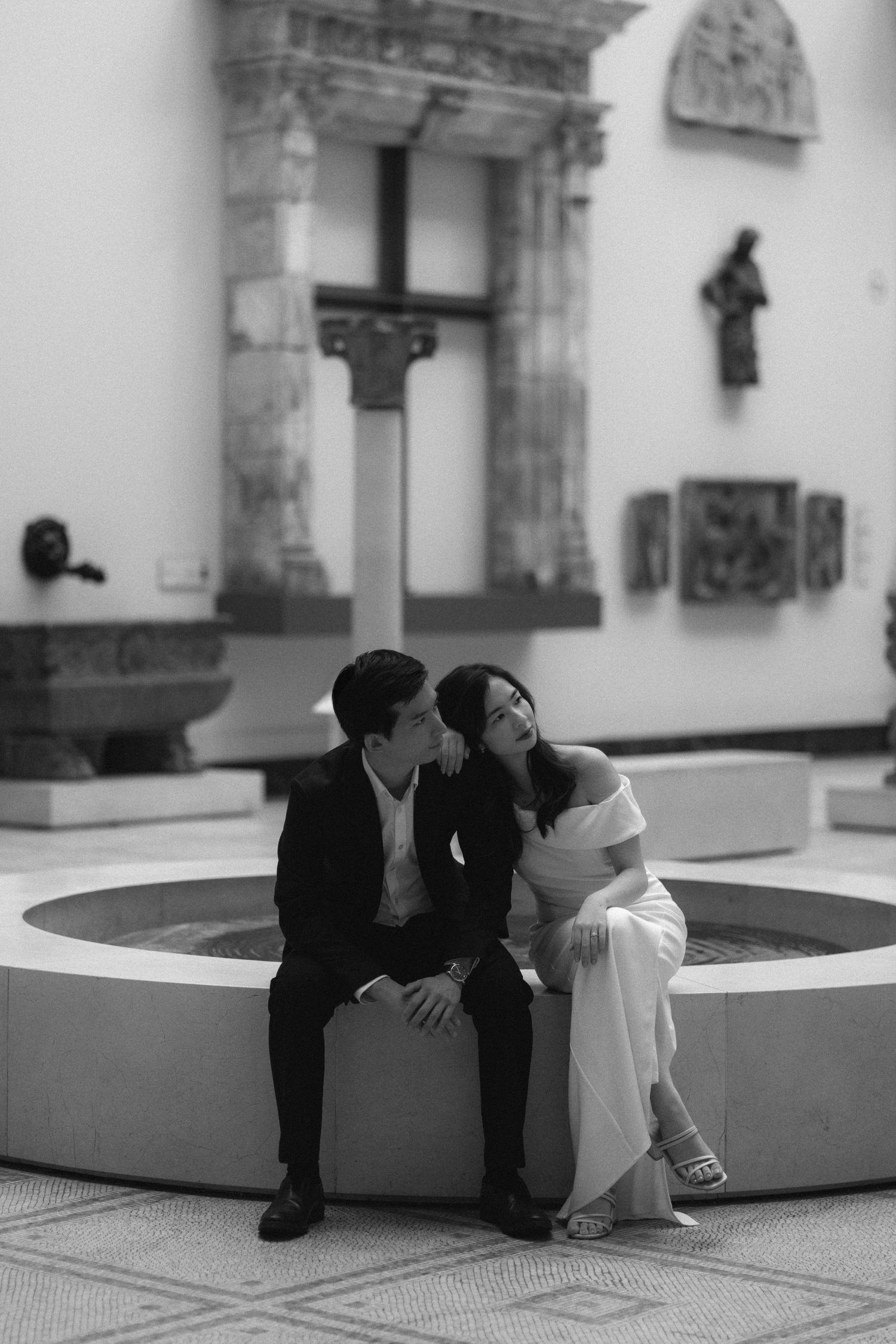 A black and white photo sequence shows a couple sitting on a curved bench in progressive intimate poses.