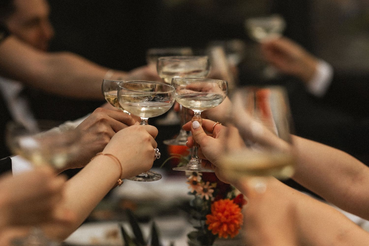 Group of people clinking champagne glasses in a celebratory toast. Captured by London photographer Jaehwa Yoon of Waviav.