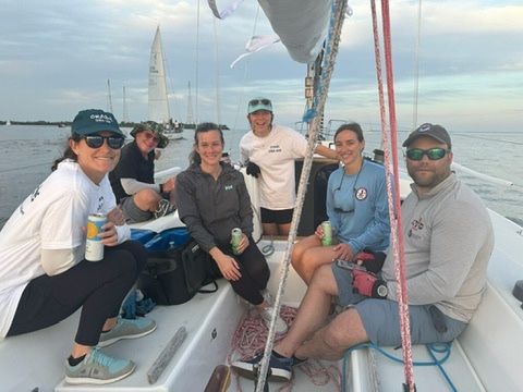 Athena Arnold marine lifestyle photographer with her sailing team after a Wednesday night race in Annapolis.