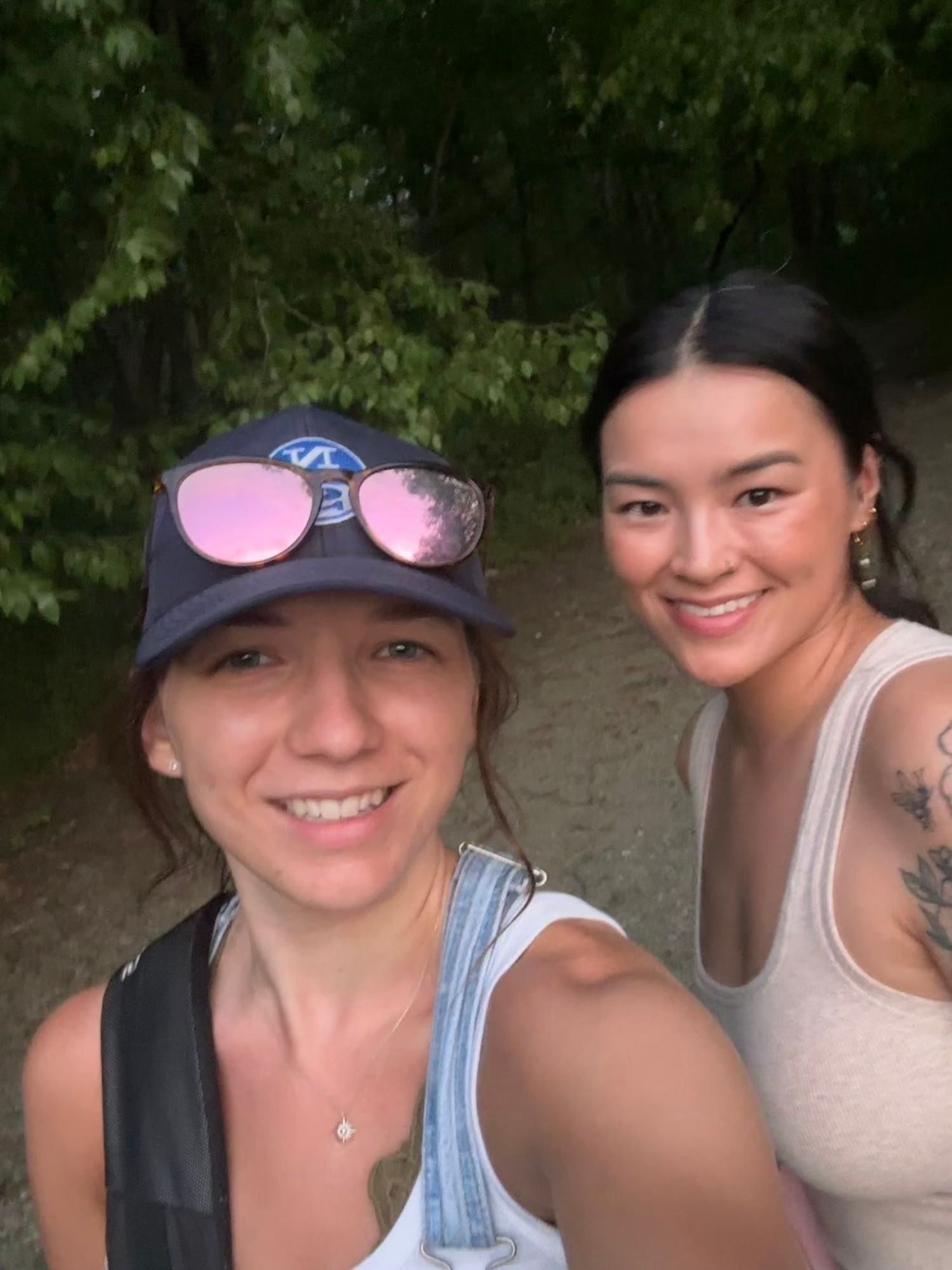 Portrait photographer Athena Arnold and model hike to photoshoot spot at park in Maryland.
