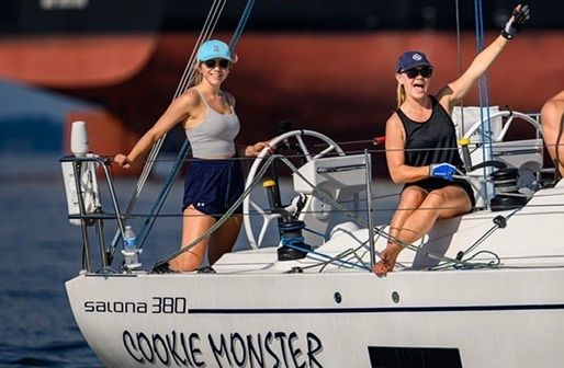 Athena Arnold, sailor and marine lifestyle photographer skippering sailboat for race in Chesapeake Bay.