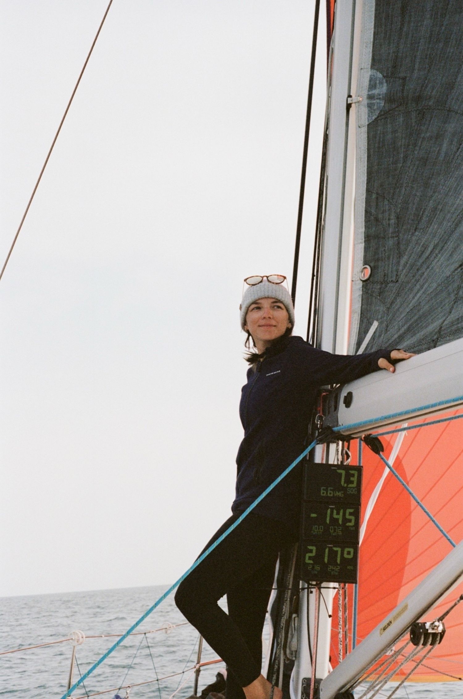 35mm film of a sailor delivering a sailboat in the ocean.