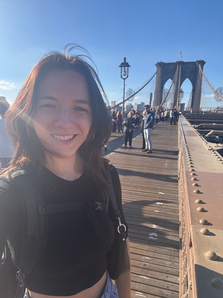 Athena Arnold concert photographer in New York City crossing the Brooklyn bridge to take pictures of a show.