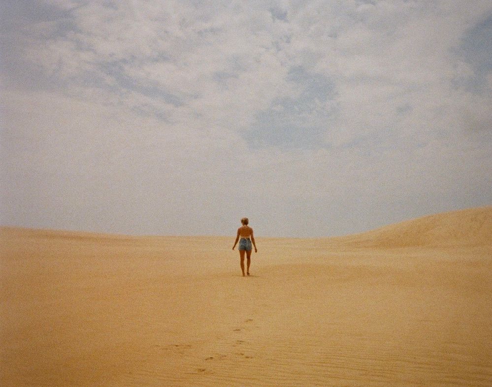 Athena Arnold adventure and travel photographer exploring Jockey's Ridge in the Outer Banks, North Carolina