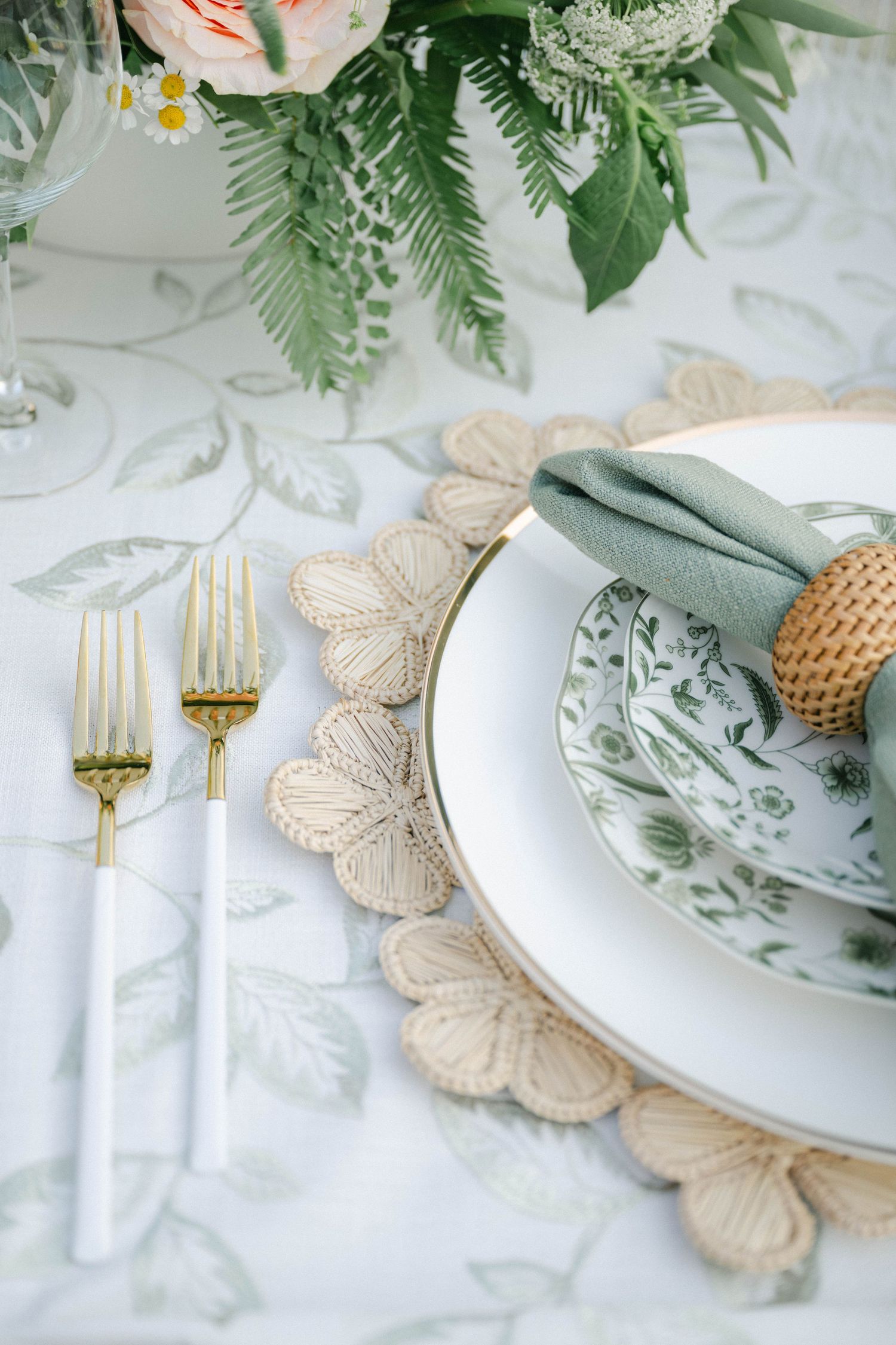 Elegant garden wedding table setting with gold flatware, floral china, woven charger, sage napkin. - Elawa Farm Wedding Reception