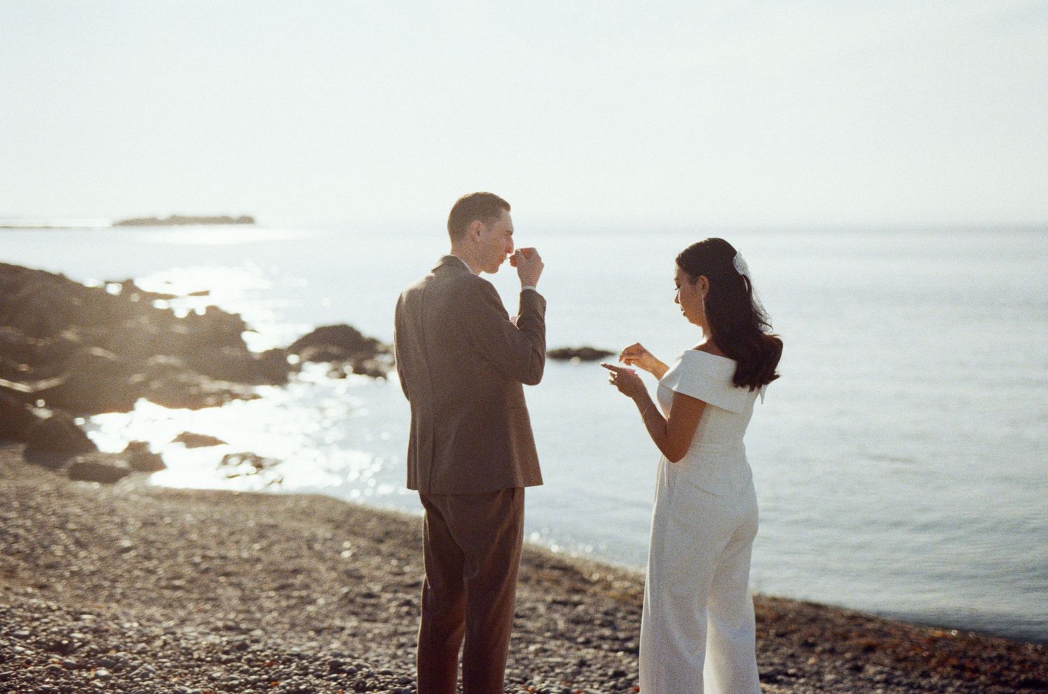 35 mm film photo of bride and groom eating ice cream on the beach in Tofino during their elopement