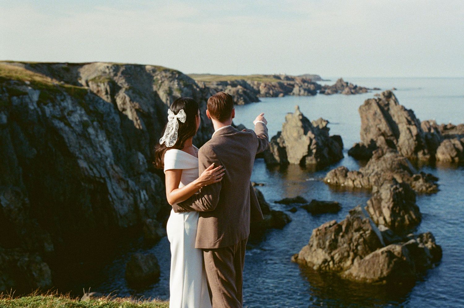 35 mm film photo of a bride and groom admiring the landscape during their elopement