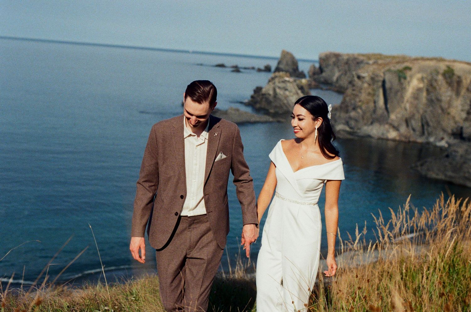35 mm film photo of bride and groom in funky outfits exploring the coast in Ucluelet during their Vancouver Island Elopement