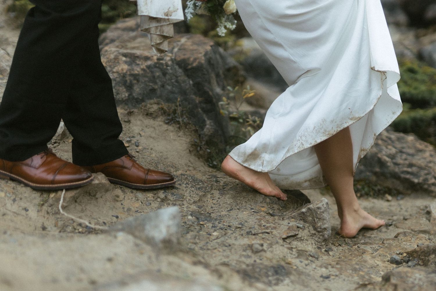 bride and groom walk barefoot along a rocky path in Yoho National Park