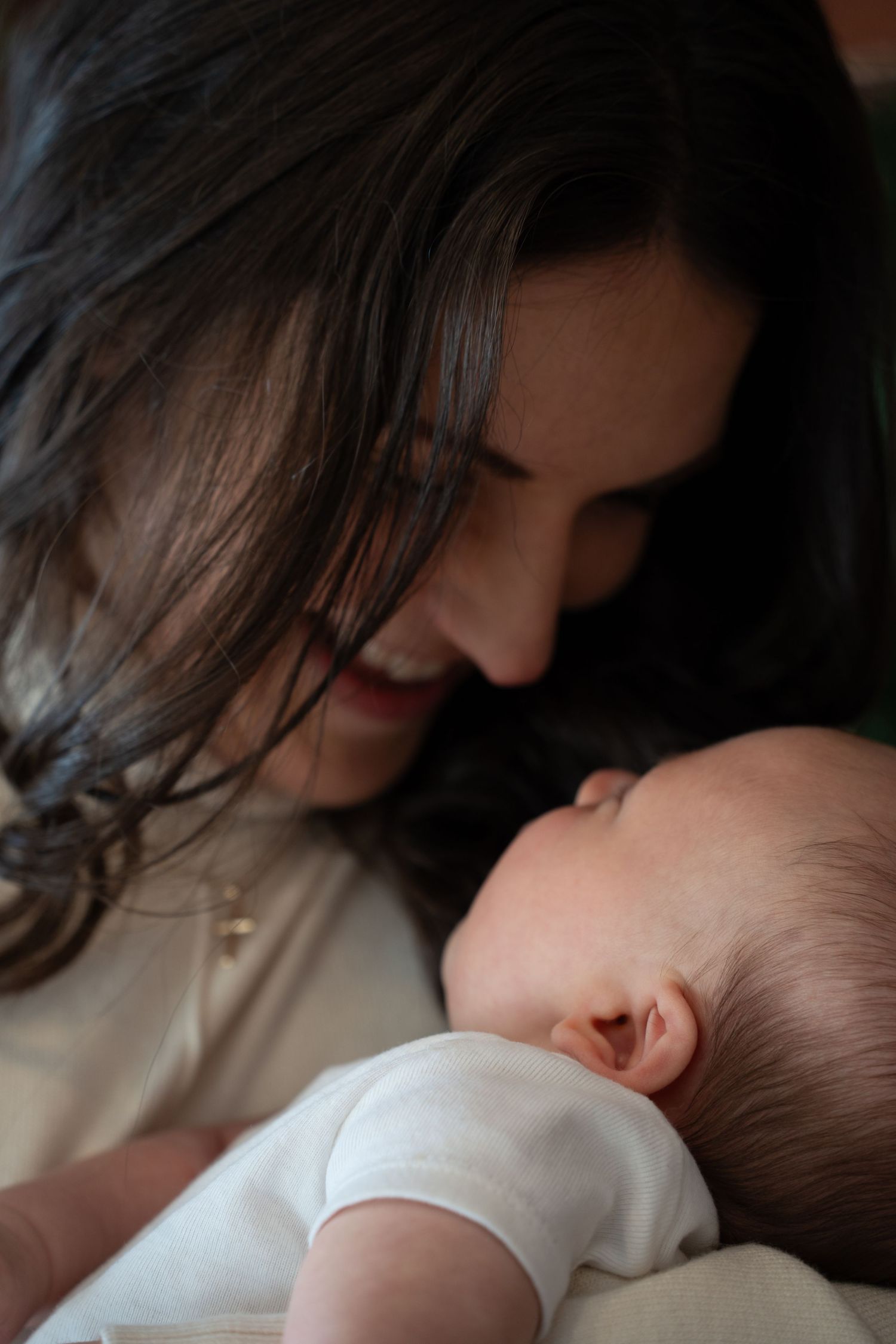 A tender moment between parent and baby as they share a gentle embrace in a series of intimate photos.