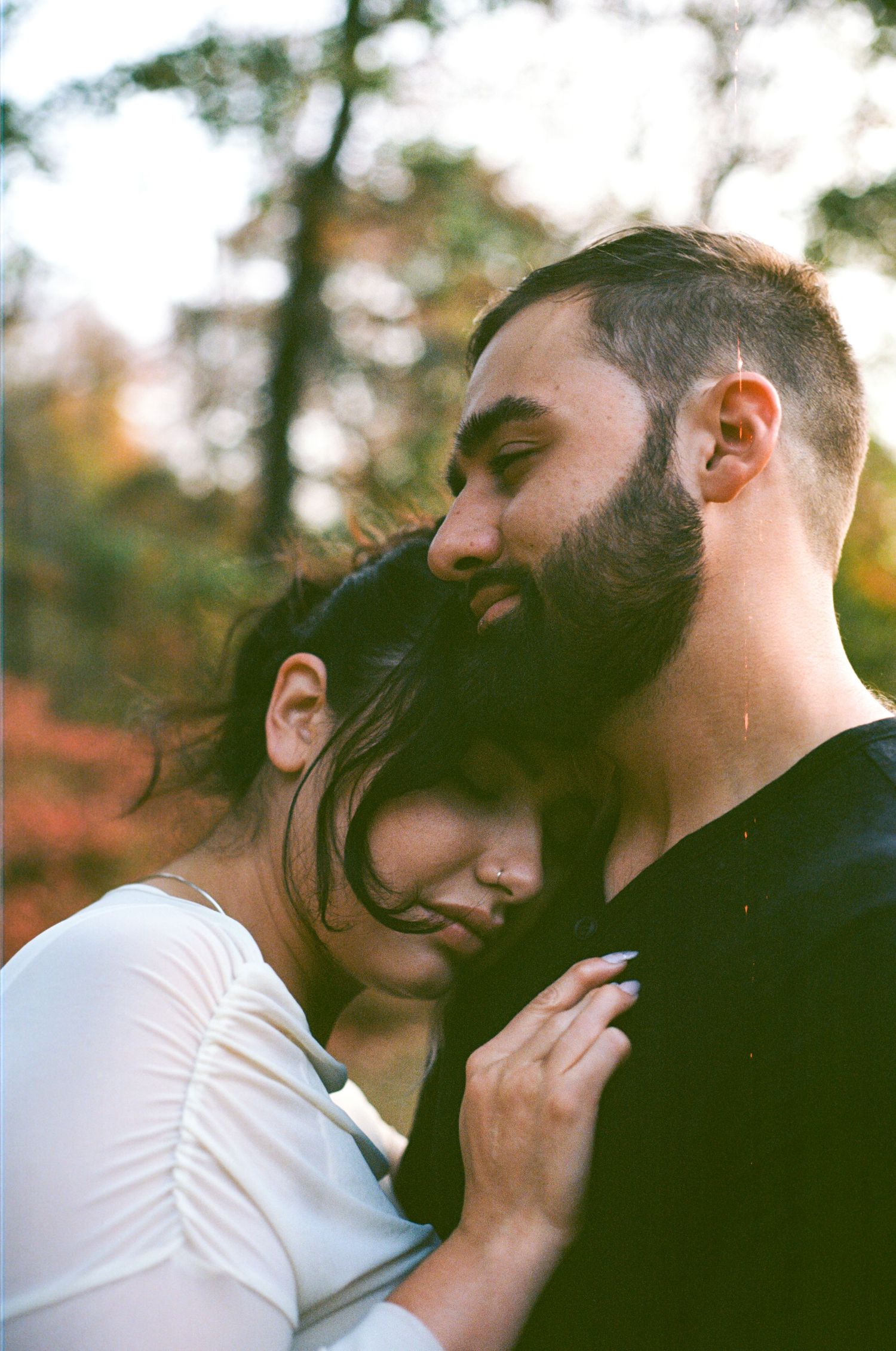 A tender romantic moment captured in a series of intimate photos showing a couple embracing in warm sunlight.