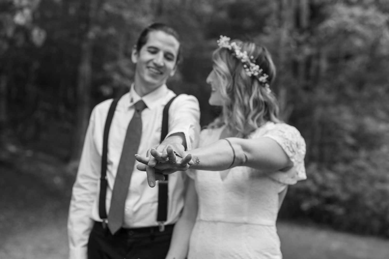 A happy couple shares a romantic moment in a garden setting during their outdoor wedding celebration.