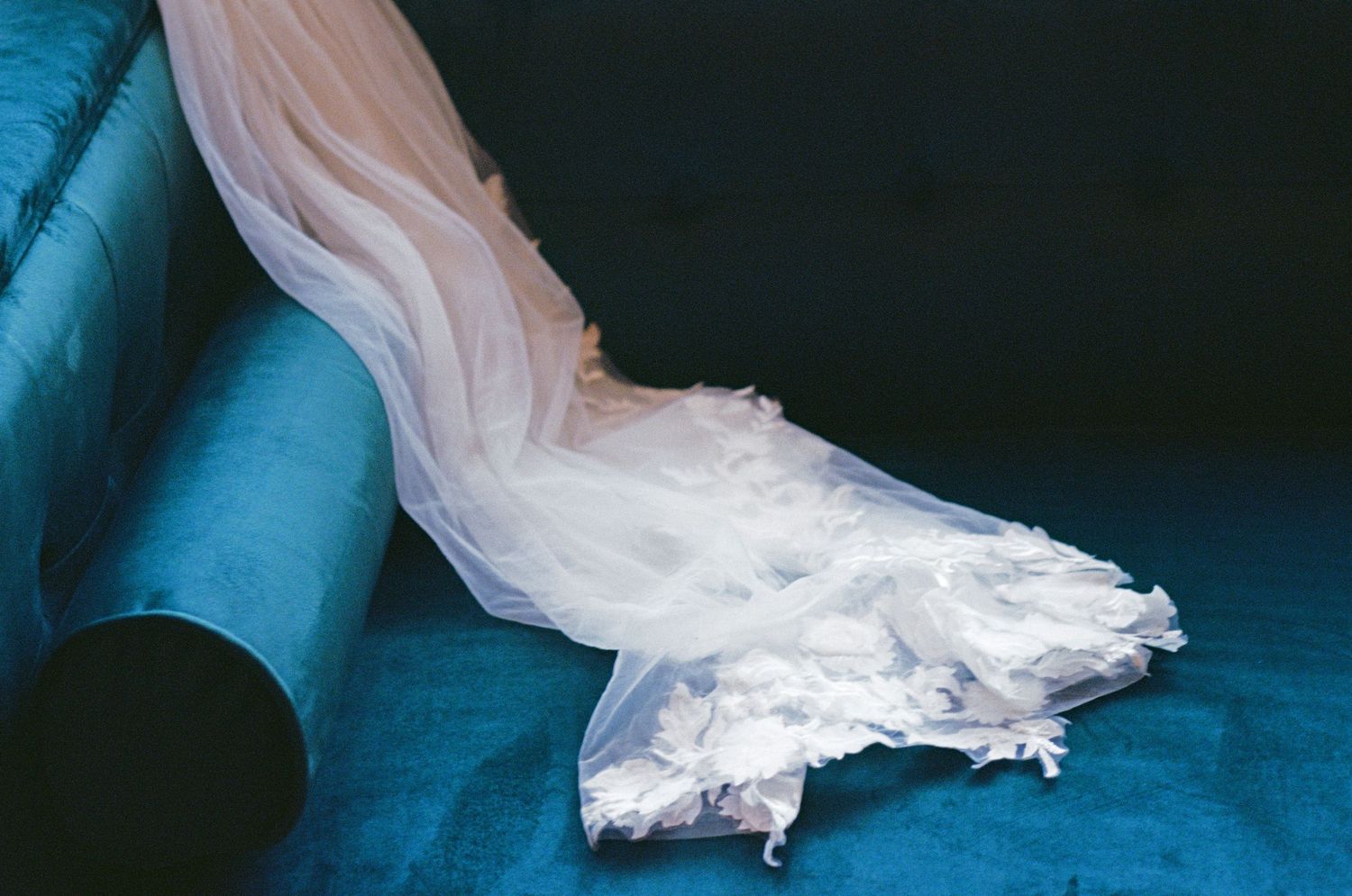 Bride's Veil placed on Bright blue couch shot on couple film.