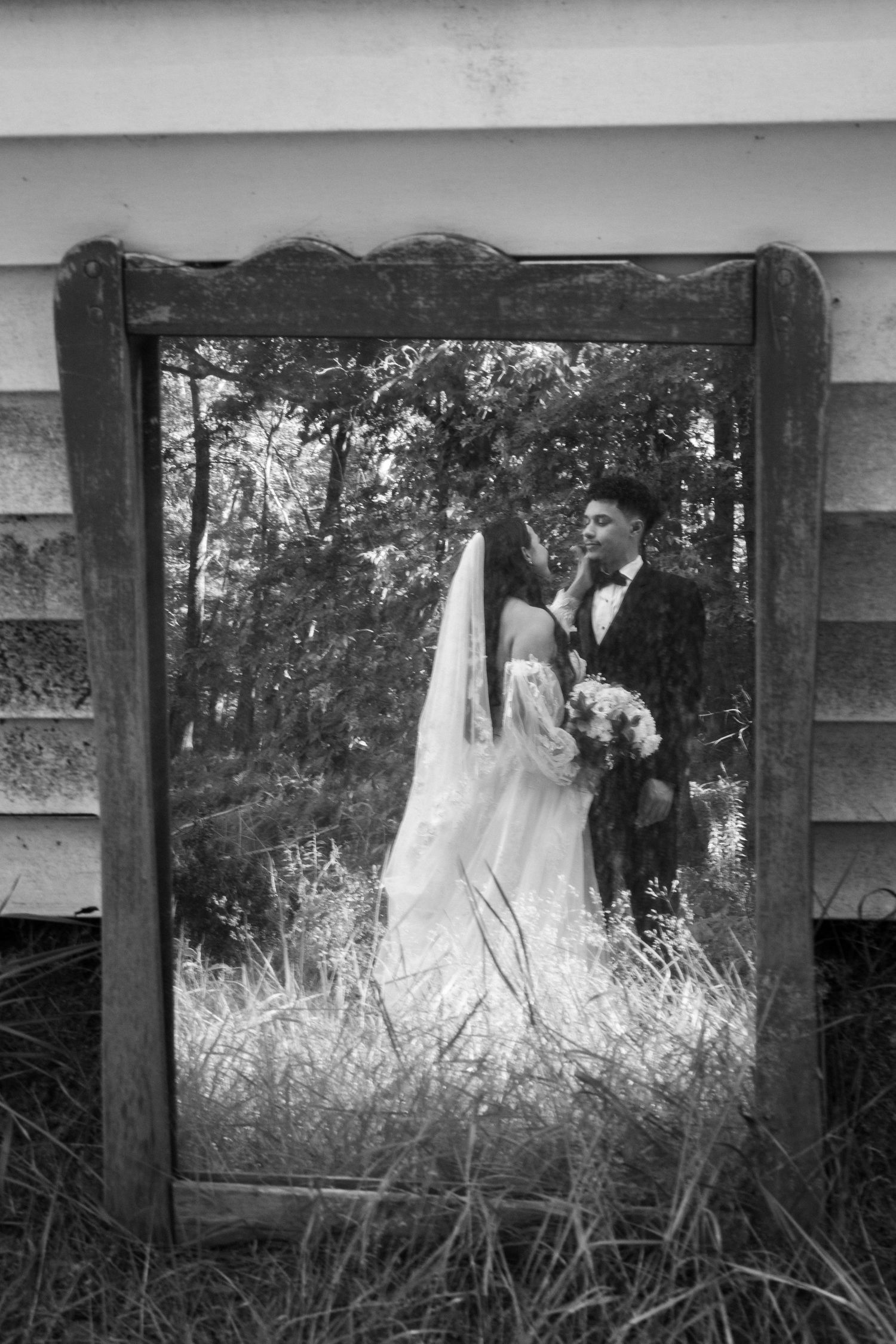 Black and white Portrait of a couple through a mirror reflection. Summer wedding Dayville, Connecticut.
