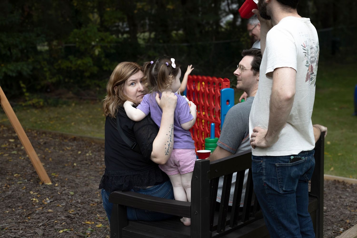 Group of people sitting on a bench at a birthday party. Westport, Connecticut