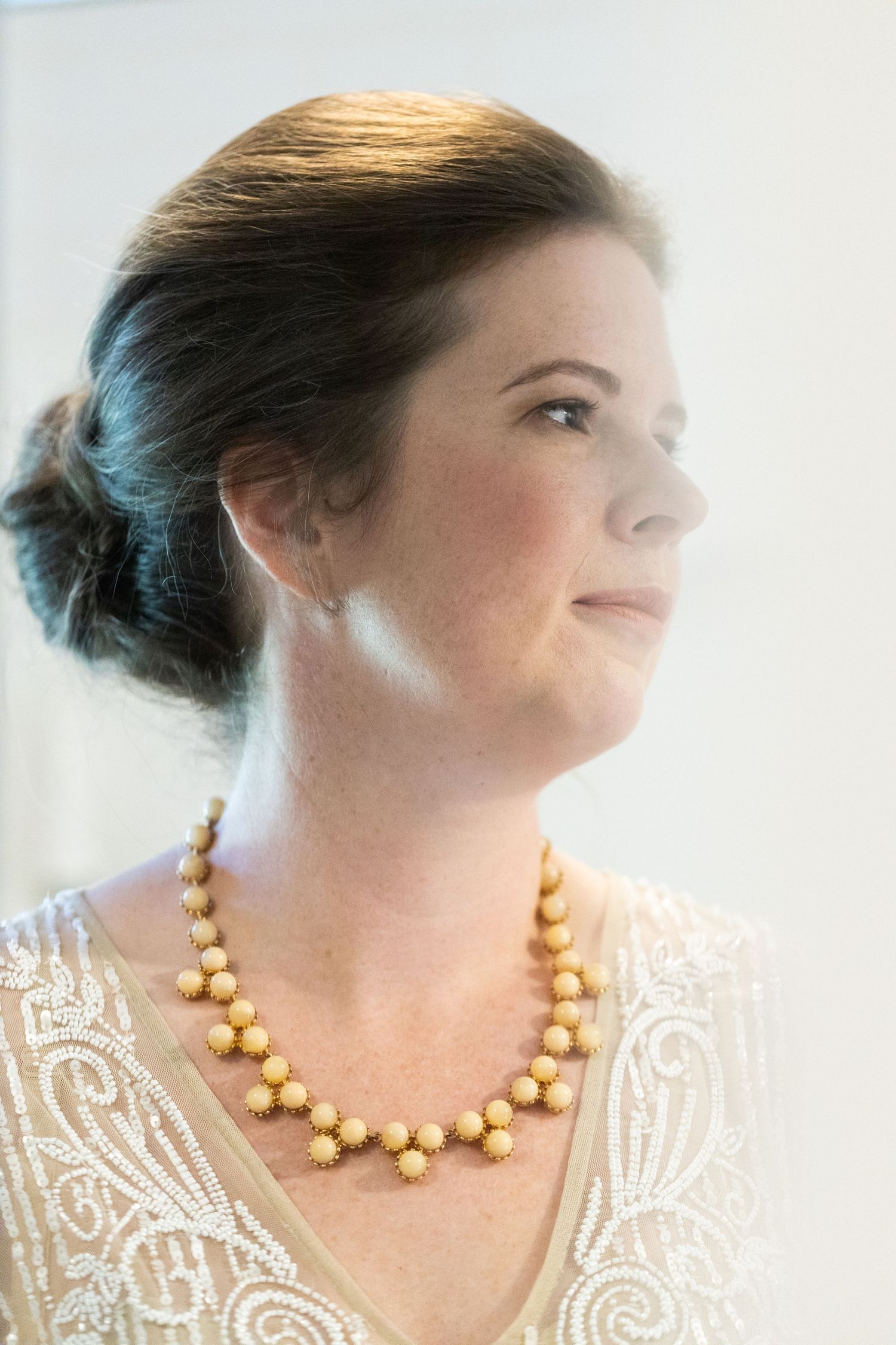 Soft etherial portrait of bride in her bathroom.