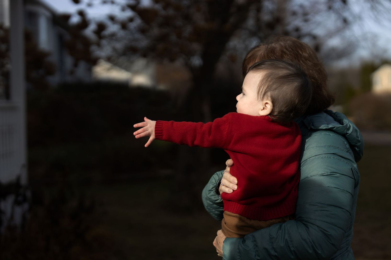 Child reaches out for parents in direct warm sunlight. Trumbull, Connecticut.