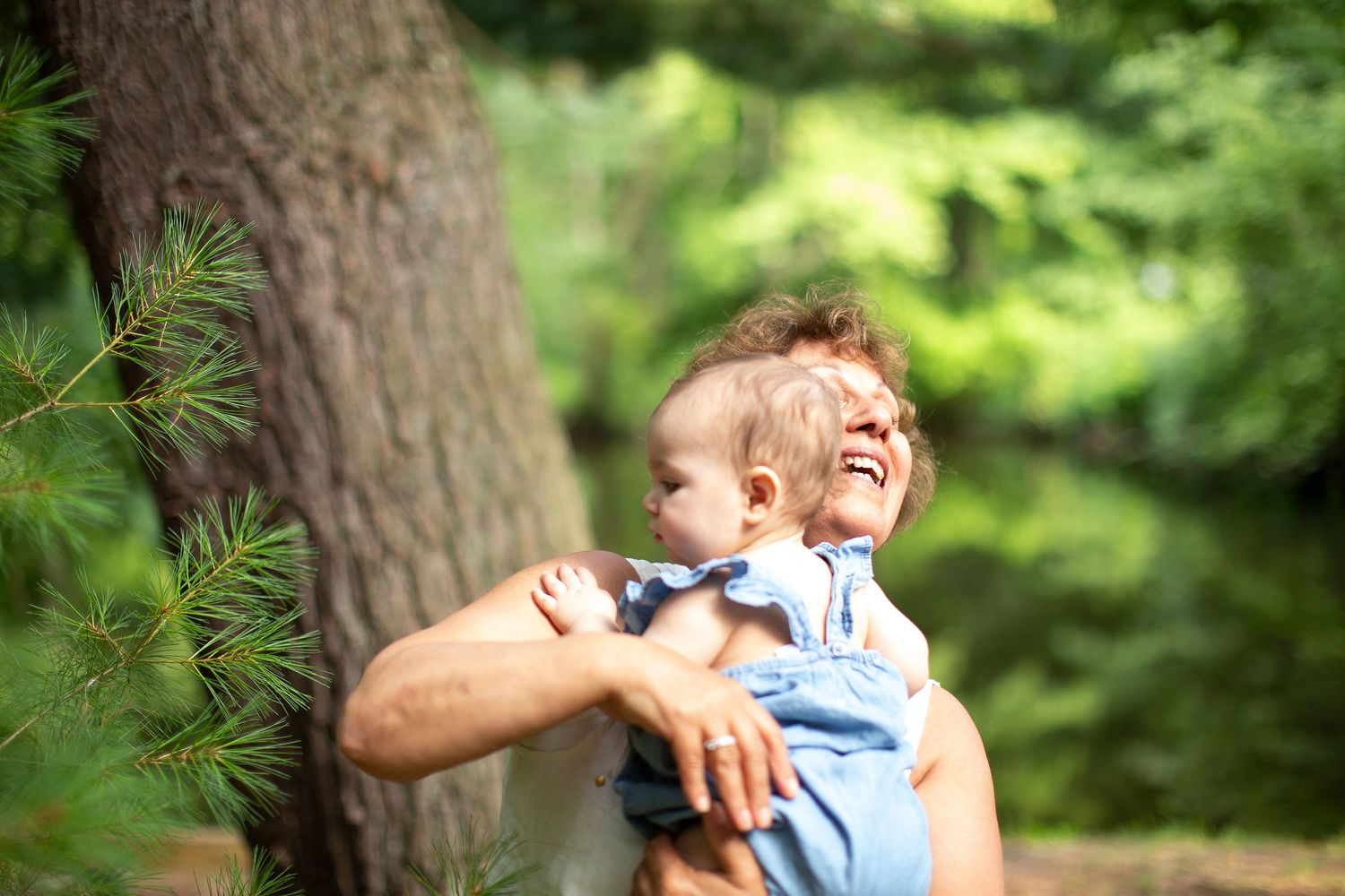 Candid Portrait of Grandma laughing while holding baby. Weston Connecticut.