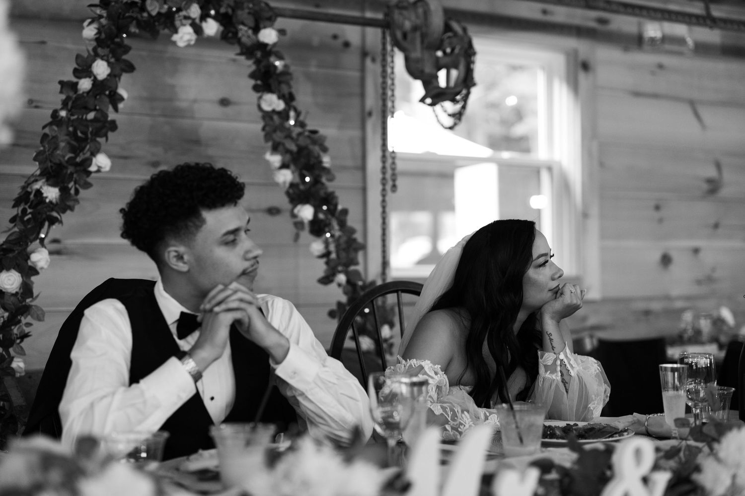 Intimate moment of bride crying during Speeches. Evergreens farms
