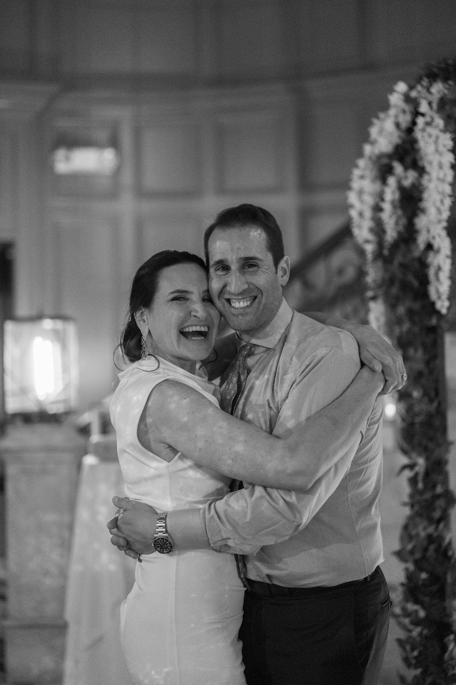A black and white photo sequence shows a couple dancing and laughing together at what appears to be a wedding reception.