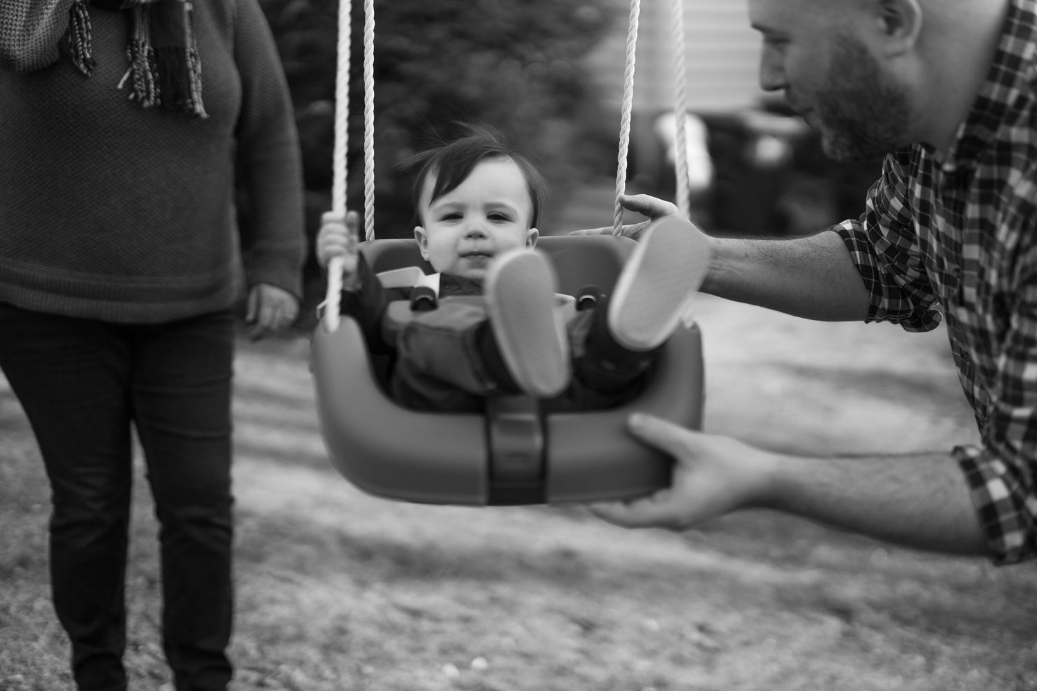Child On swing. Motion Blur. Candid family portrait.