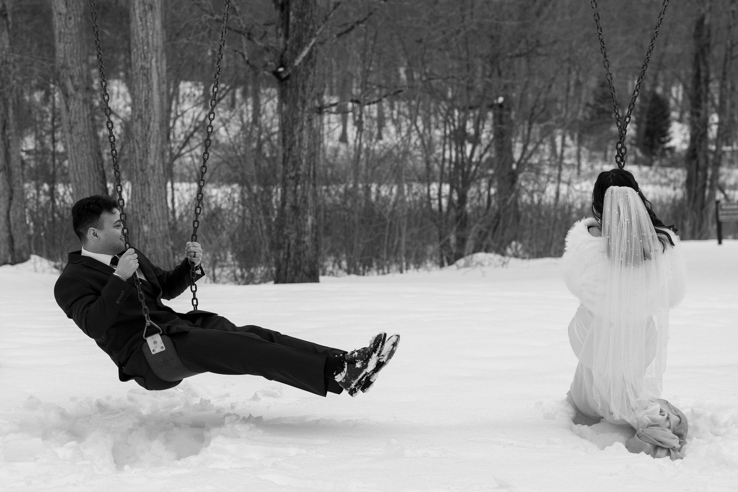 winter Elopement. Couple sits on wings at a snow party after being married. redding Connecticut.