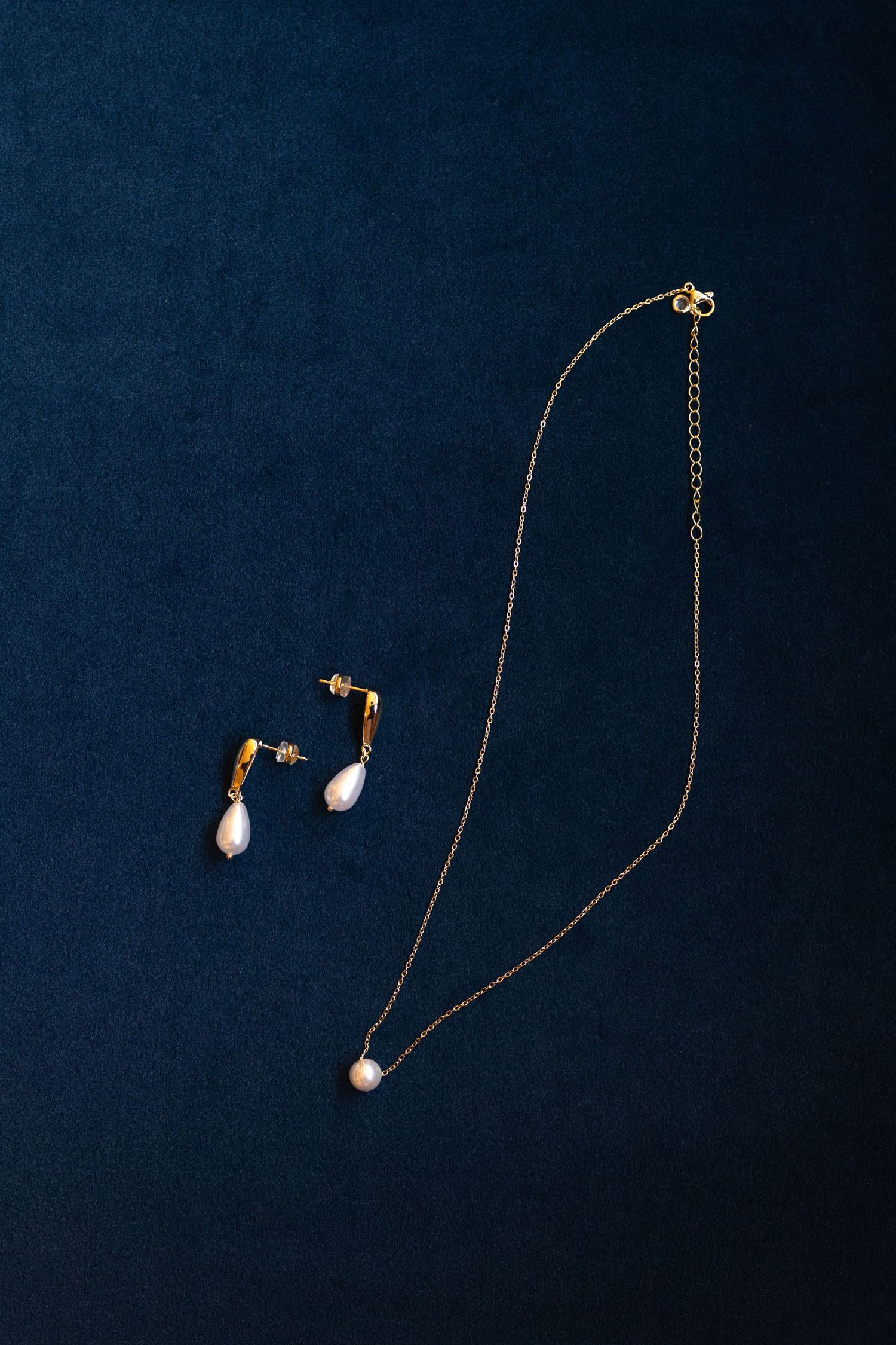 Detail Photo of brides jewelry photographed on a blue velvet couch at Evergreen Farms. Dayville, Connecticut.