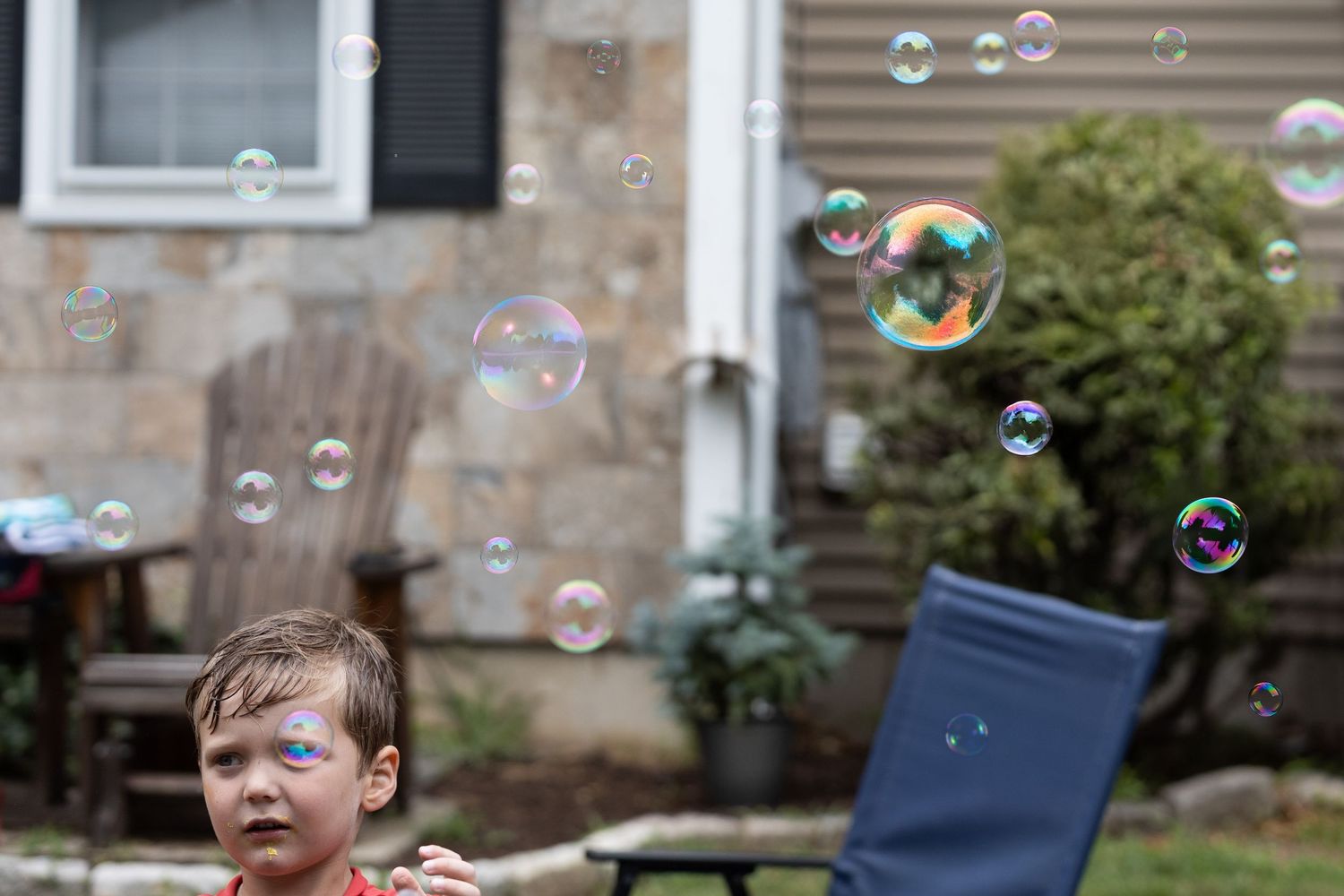 Portrait of Child, bubbles fill the frame.