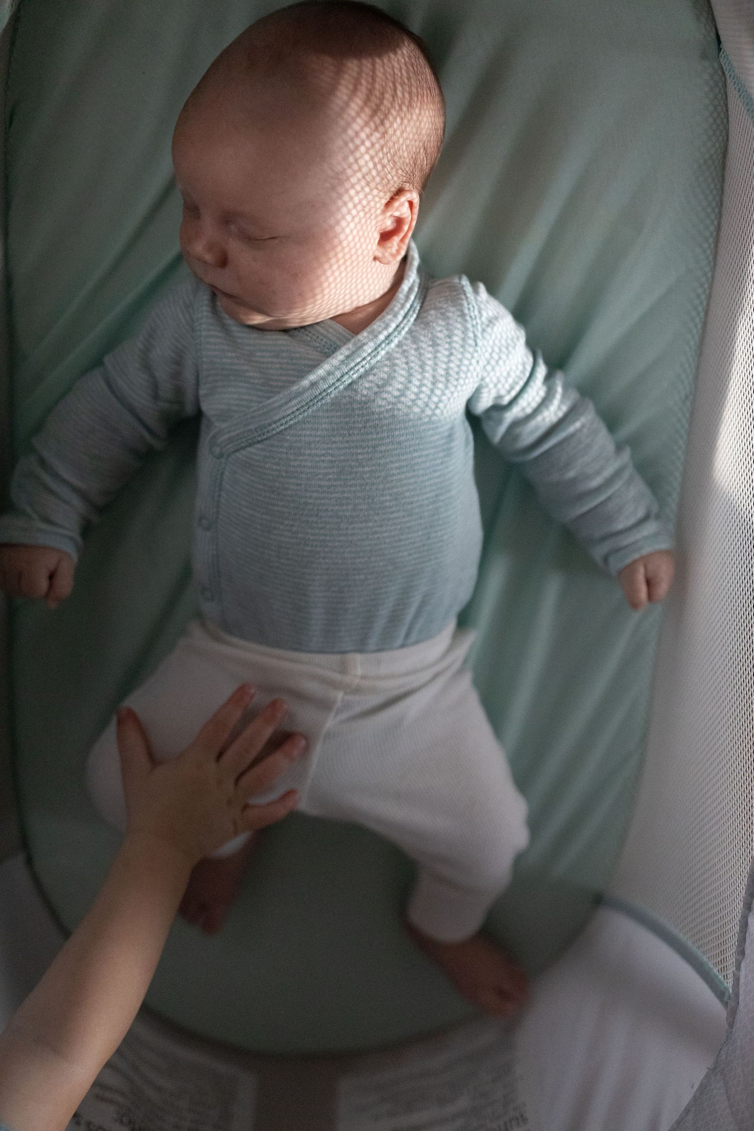 Artistic Light Pattern on Newborns Face. Documentary style newborn session. In home family session. Branford Connecticut.