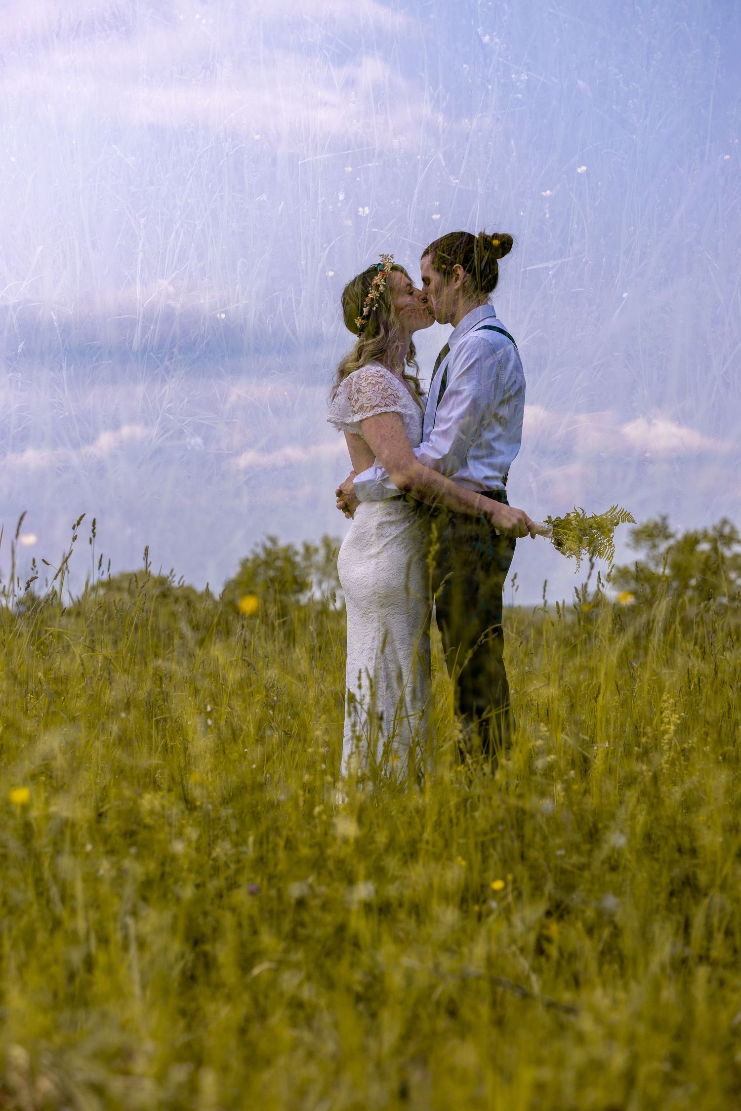 Double exposure portrait of newlyweds kissing in tall grass. bethel Connecticut.