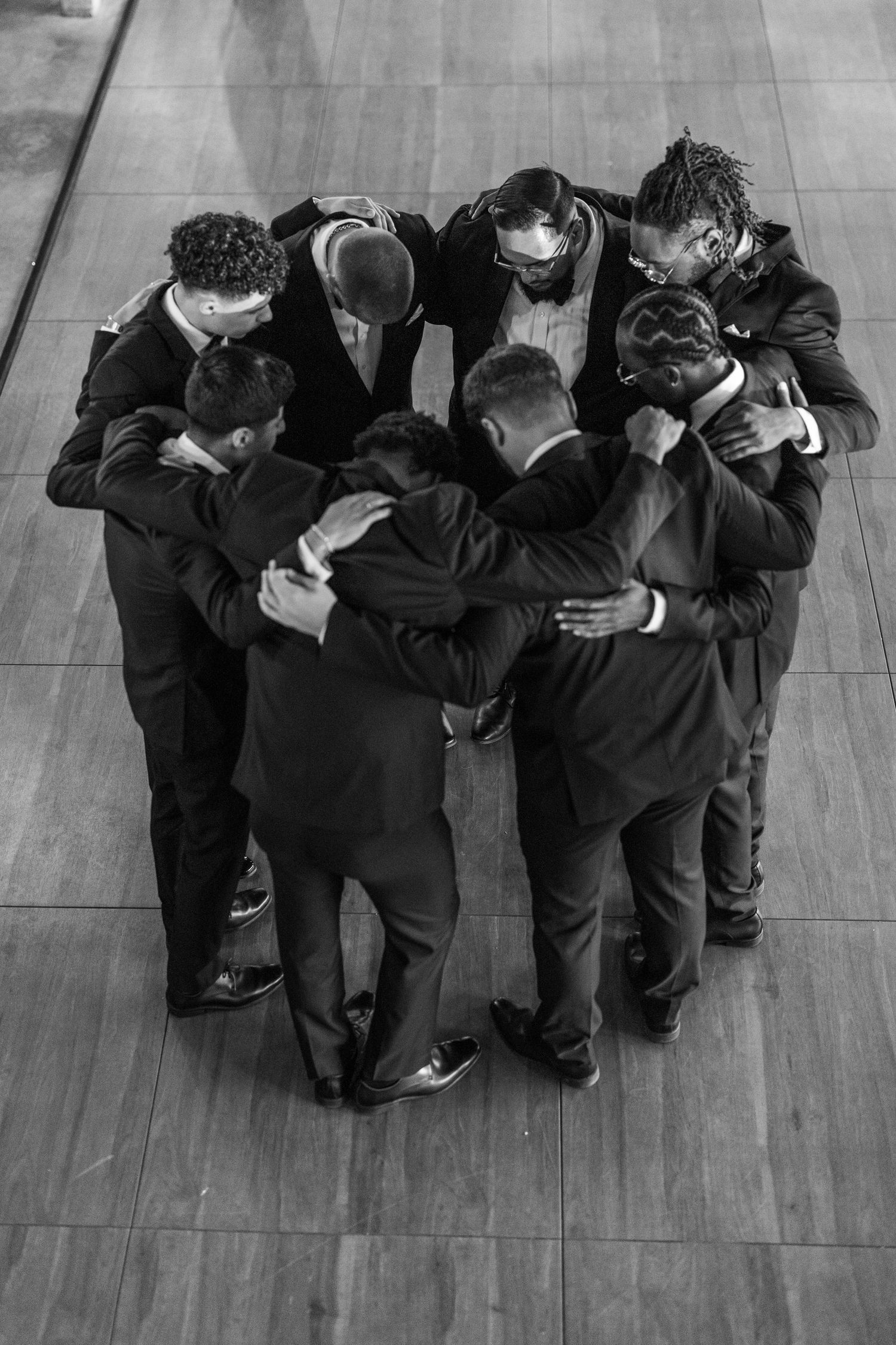 Portrait of groomsman Praying in a group before the wedding ceremony