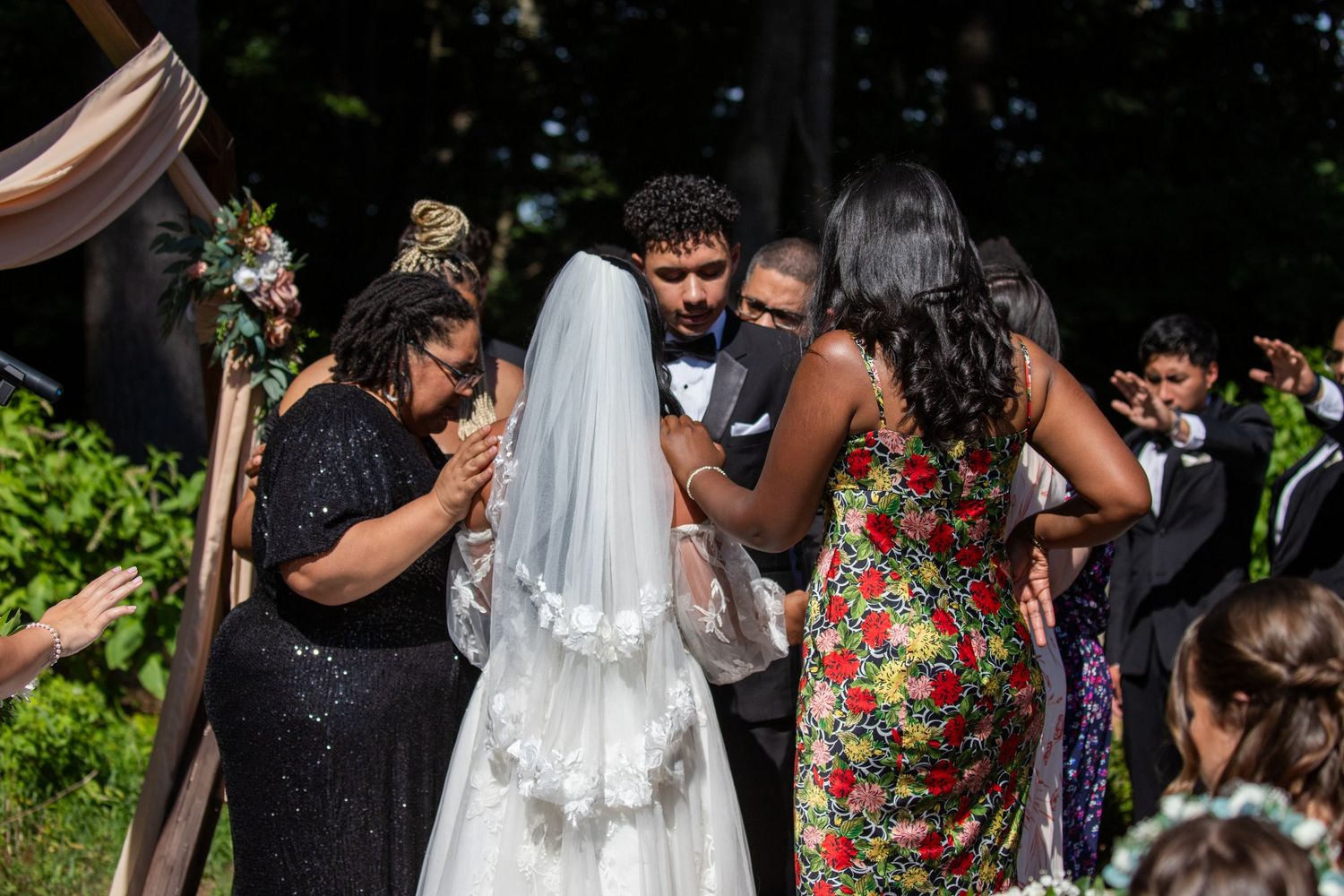 Guests perform a blessing for bride and groom during ceremony at summer wedding at Evergreen Farms. Dayville, Connecticut.