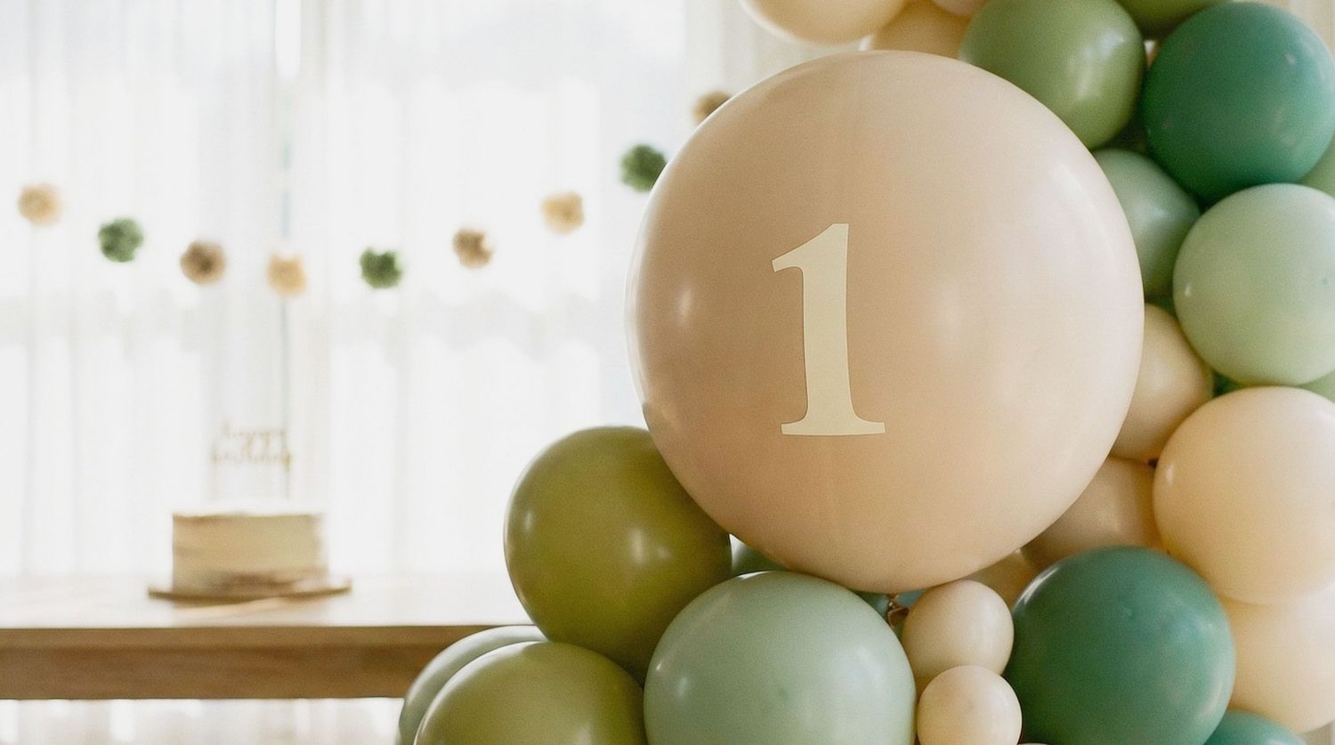 Happy toddler celebrating a first birthday with a cake smash session in a Chesterfield home.