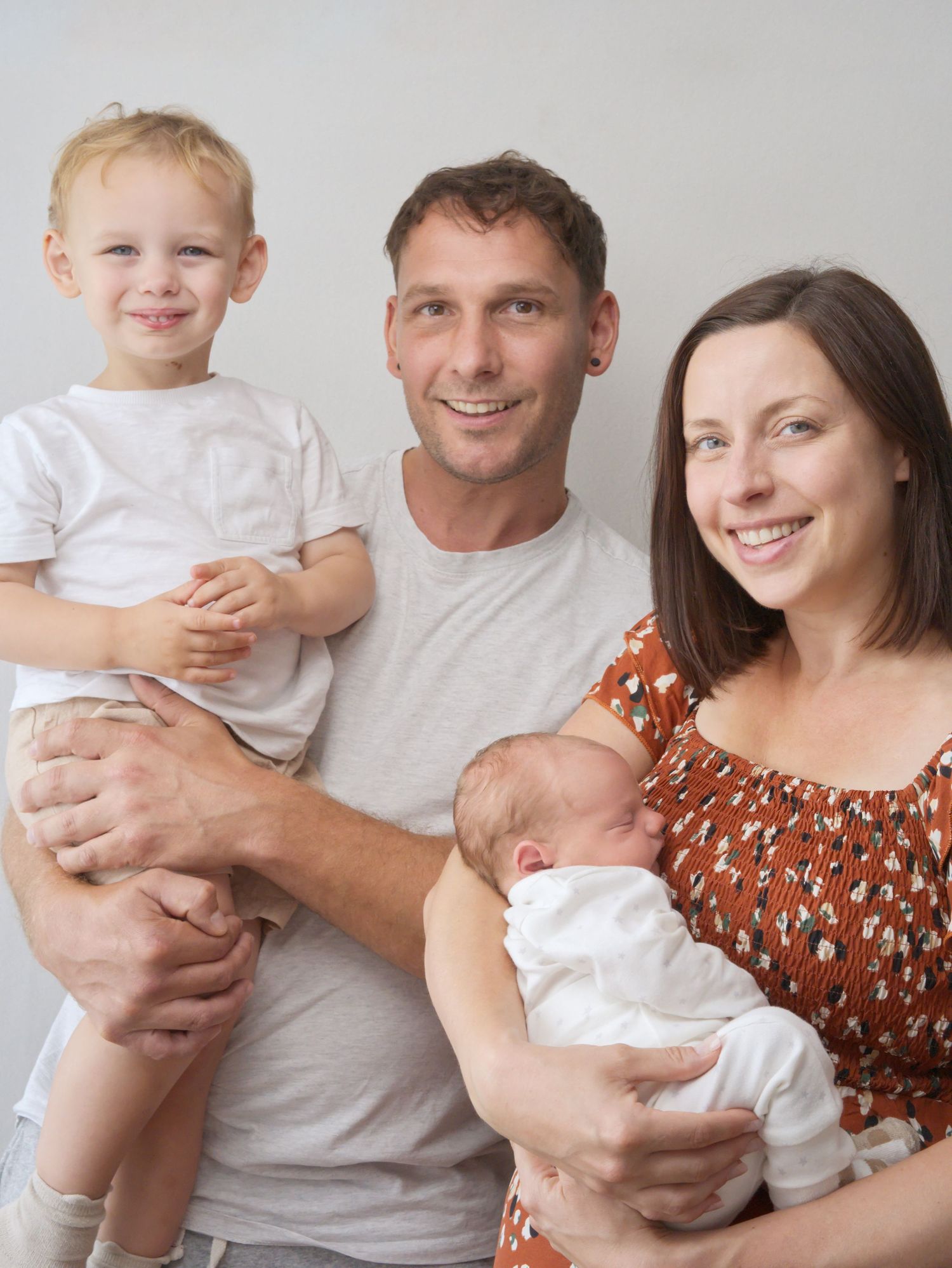 Family in home photo session with a newborn in Newbold