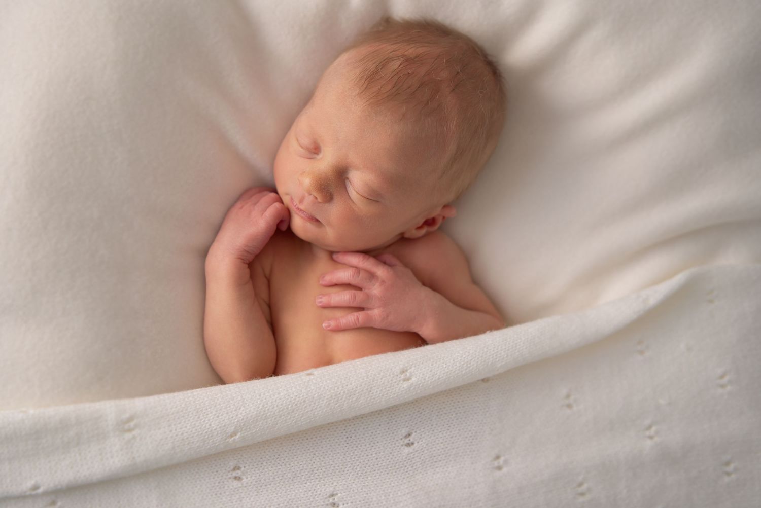 Close-up of a newborn's face captured during a baby-led photography session in Wingerworth.