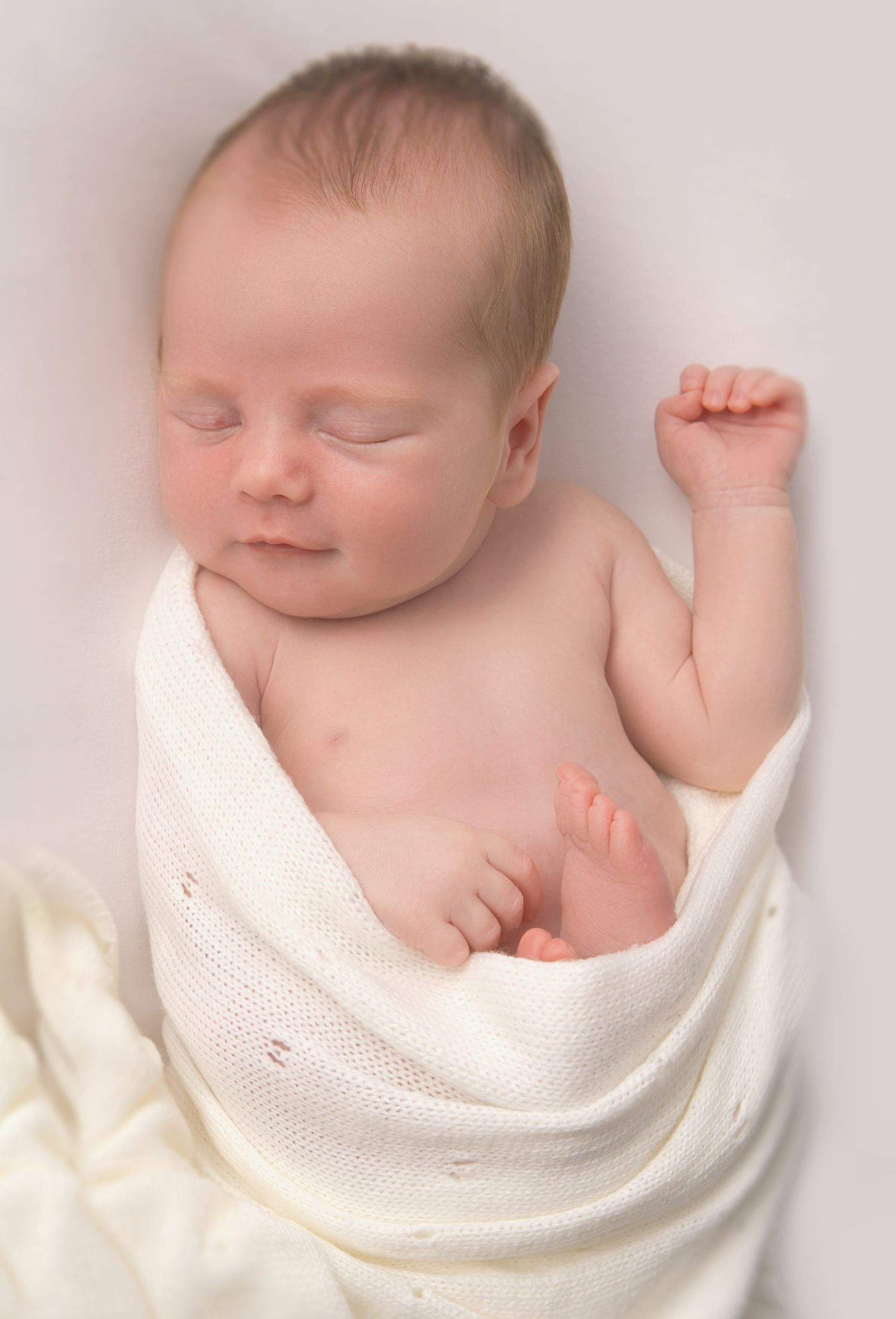 Close-up of a newborn's tiny hands captured during a baby-led photography session in Bolsover.