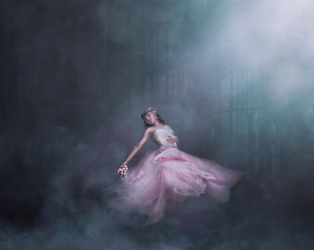 A dreamy photo series shows a ballet dancer in a pink tutu performing graceful movements through misty fog.