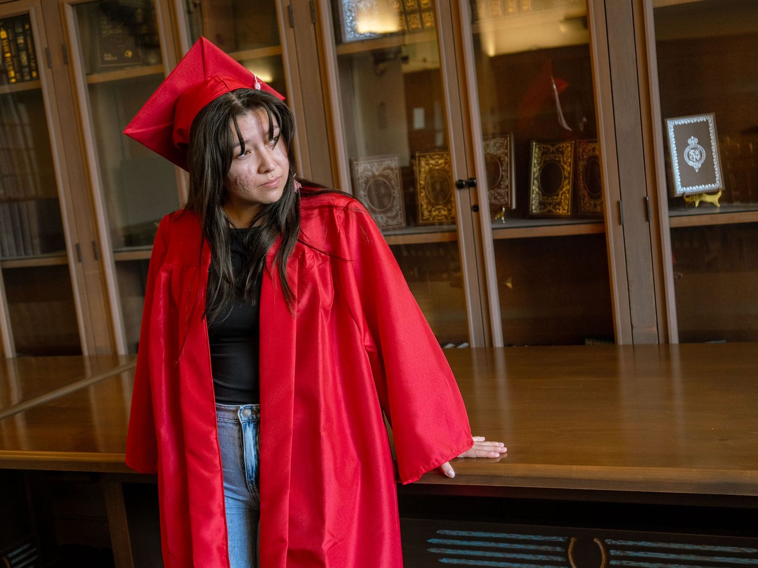 a unm graduate leaning on a table