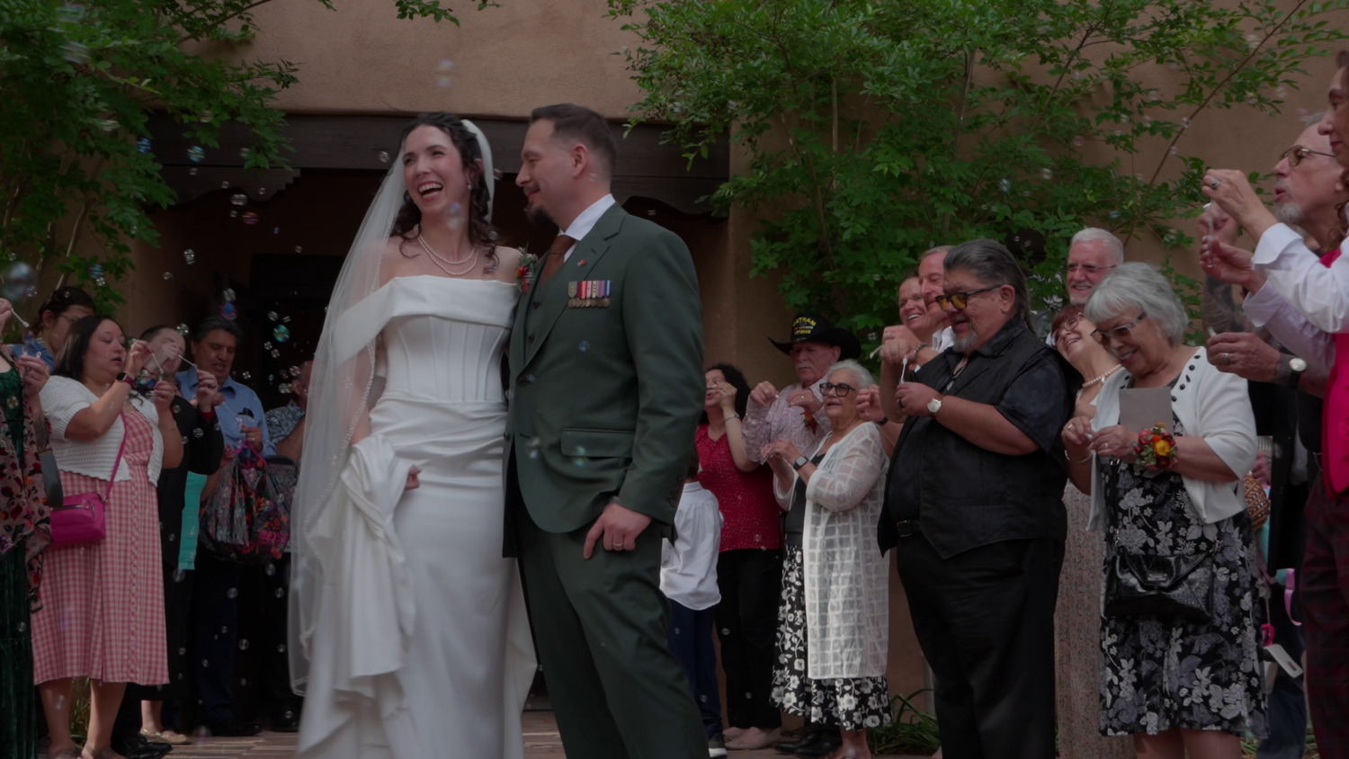 a bride and groom surrounded by family